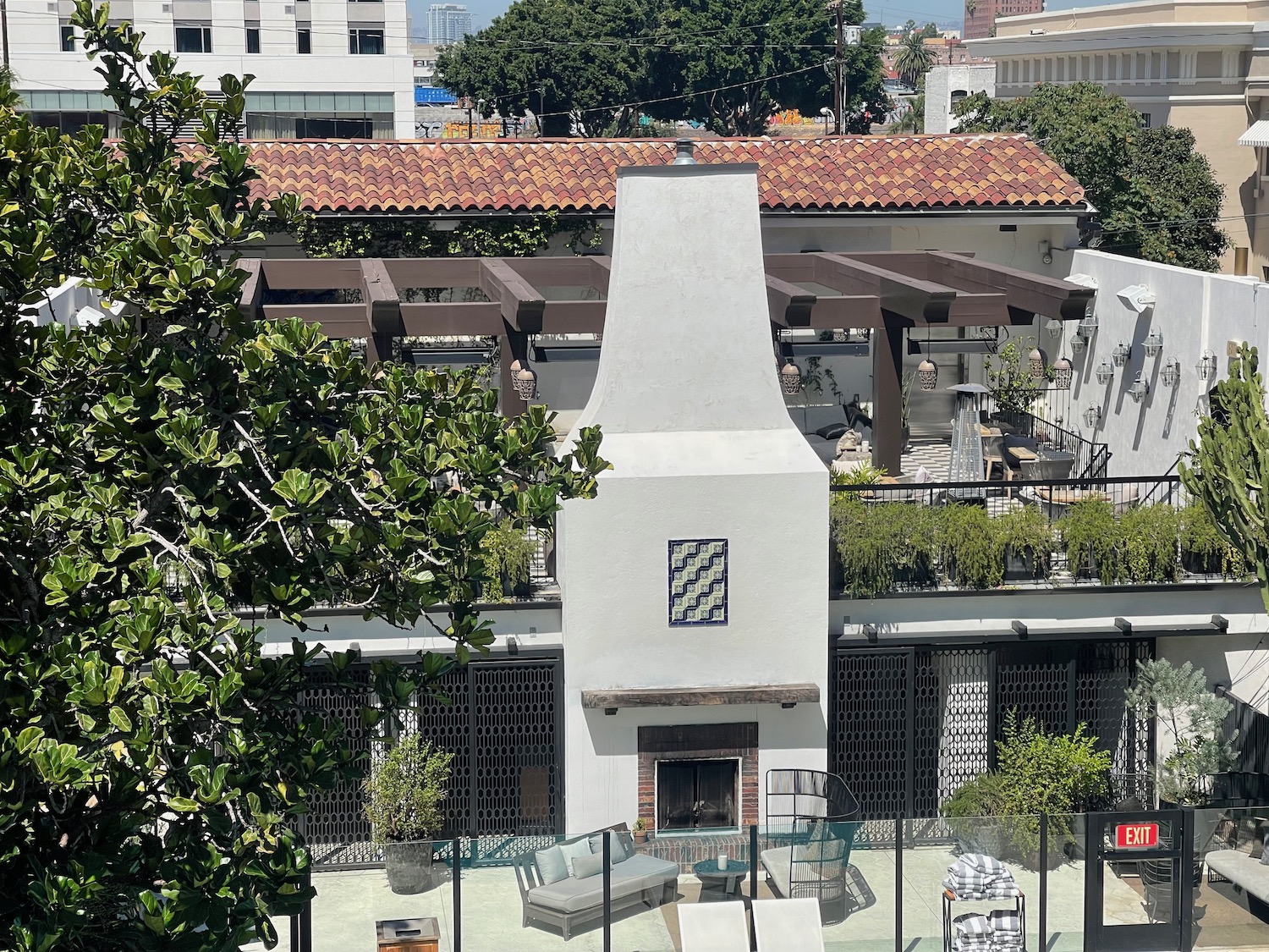 a white building with a fence and trees