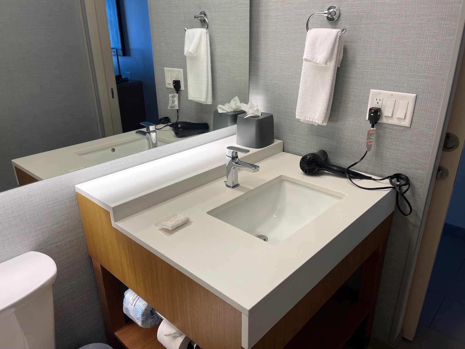 a bathroom sink with a mirror and towels