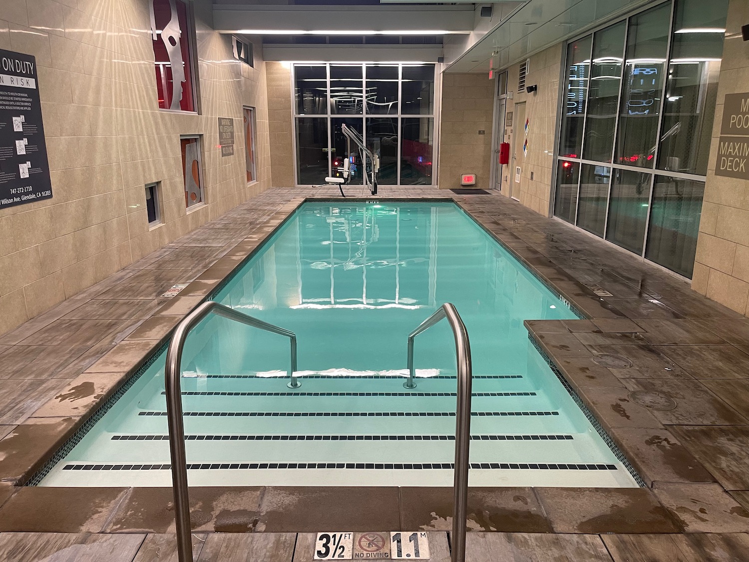 a swimming pool with stairs leading to a building