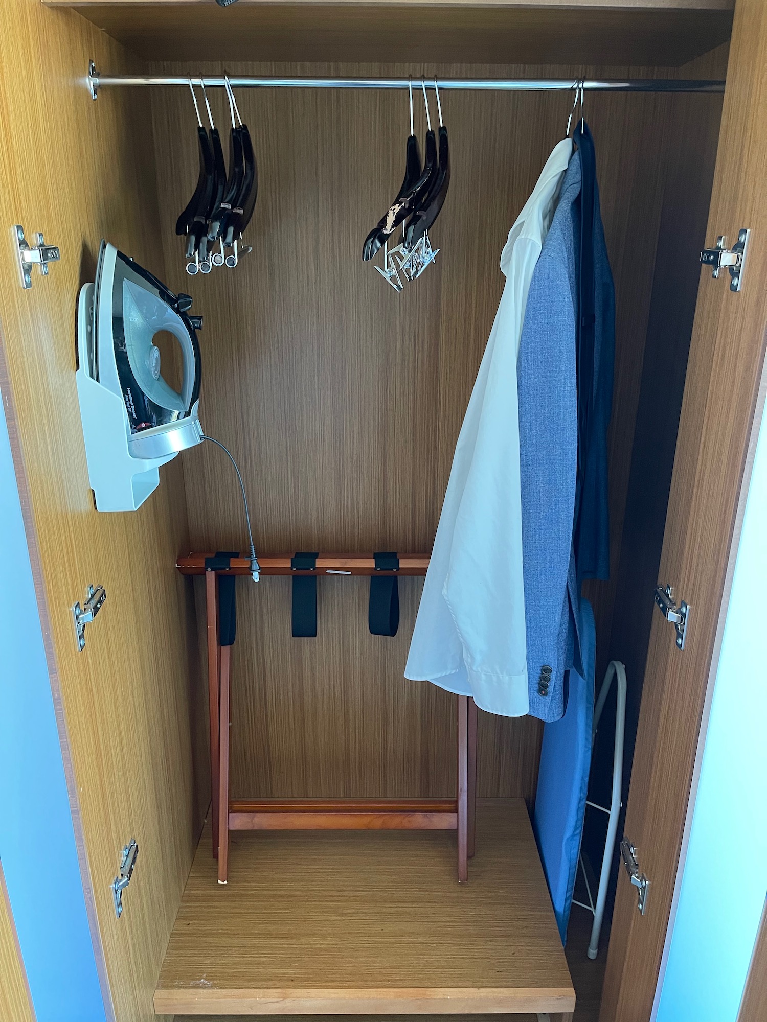 a closet with clothes on hooks