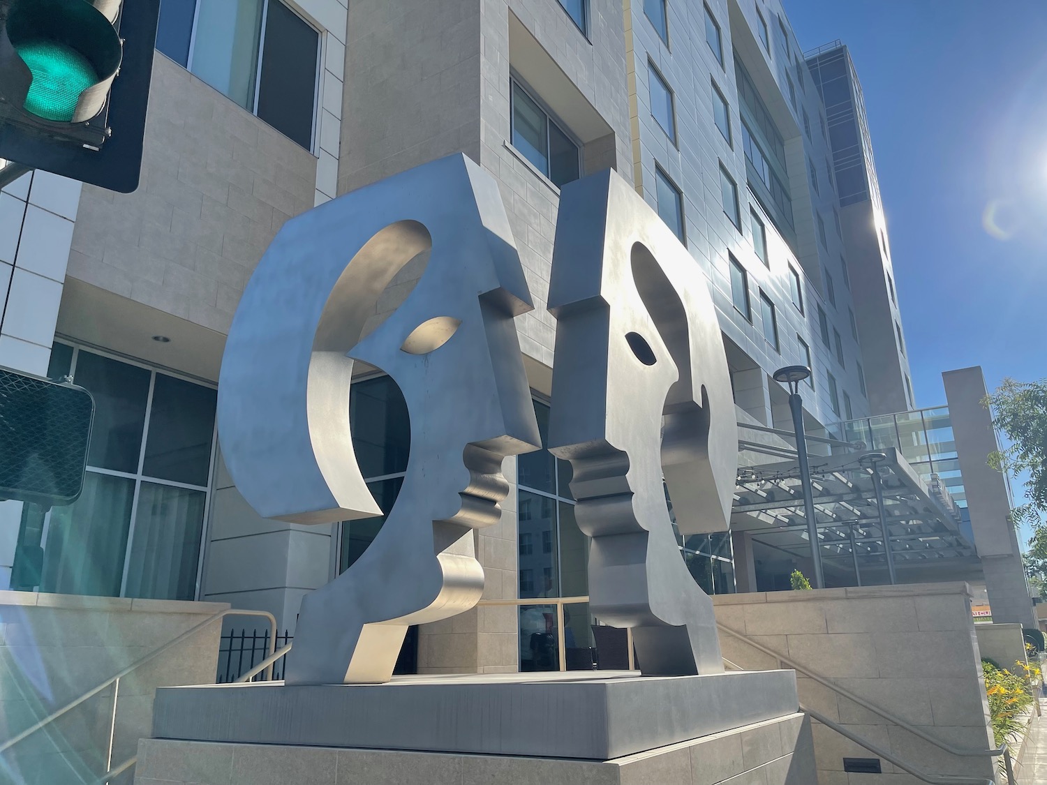 a statue of two heads in front of a building