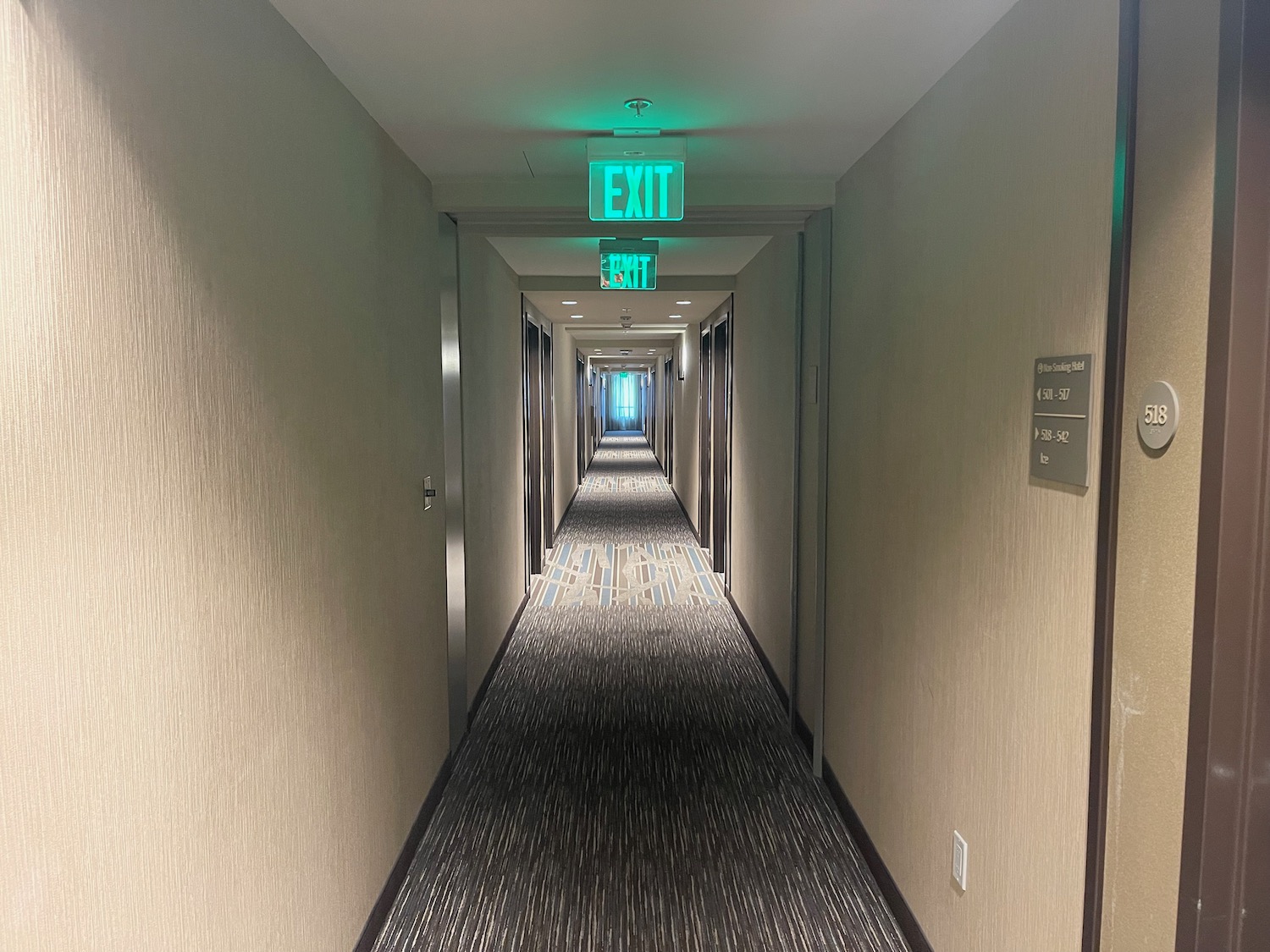 a hallway with signs on the ceiling