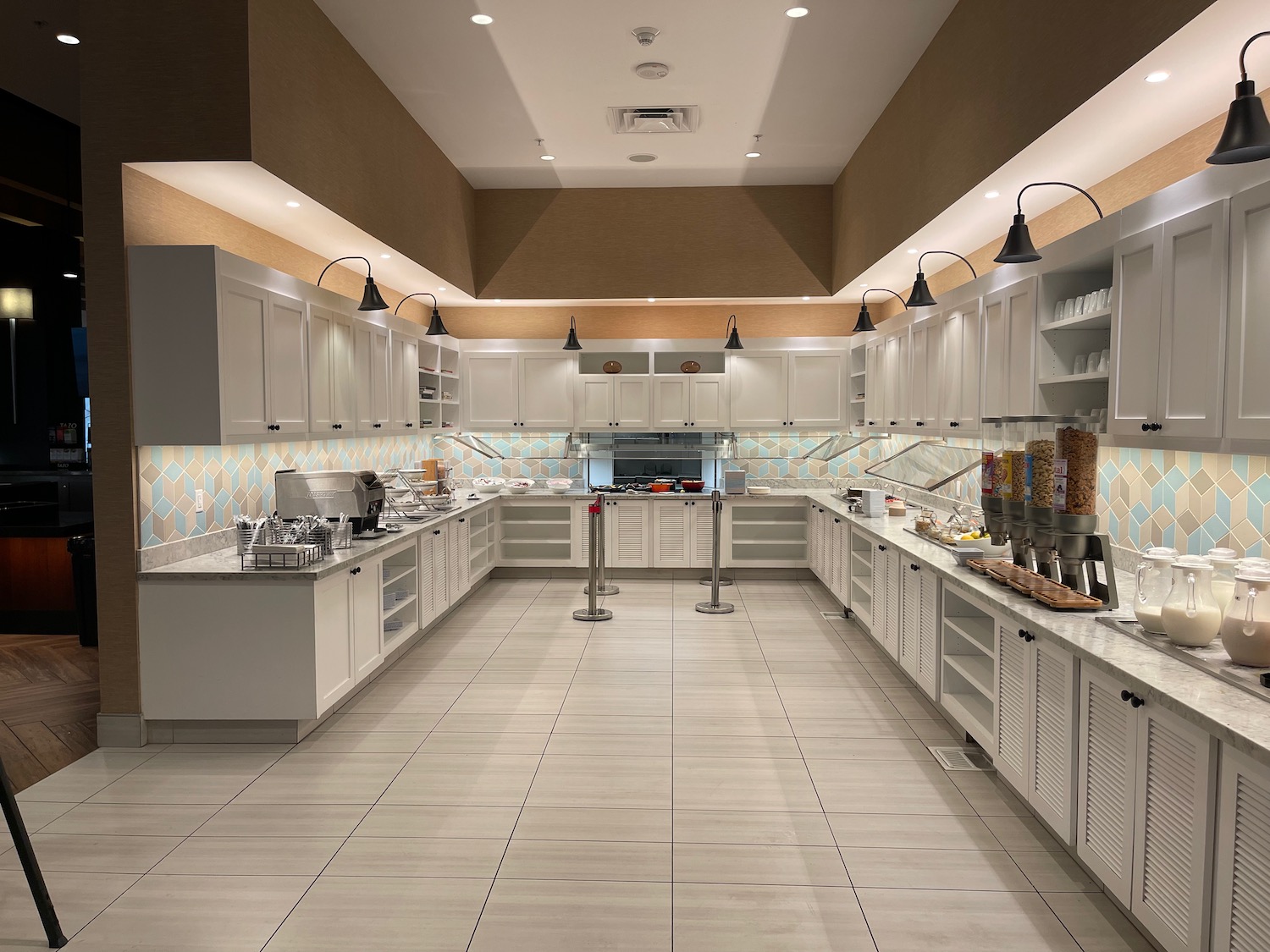 a kitchen with white cabinets and a large counter