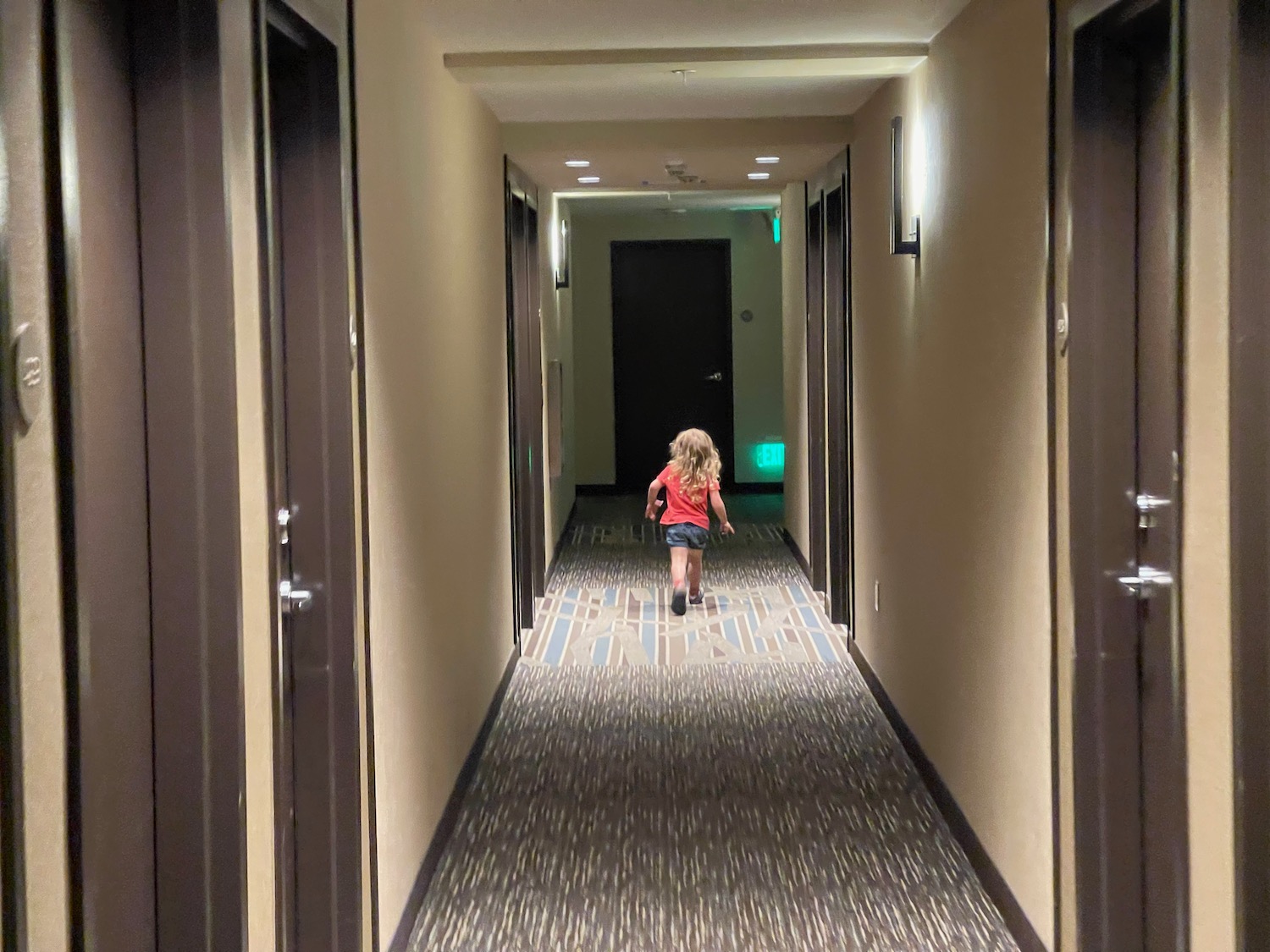 a girl walking down a hallway