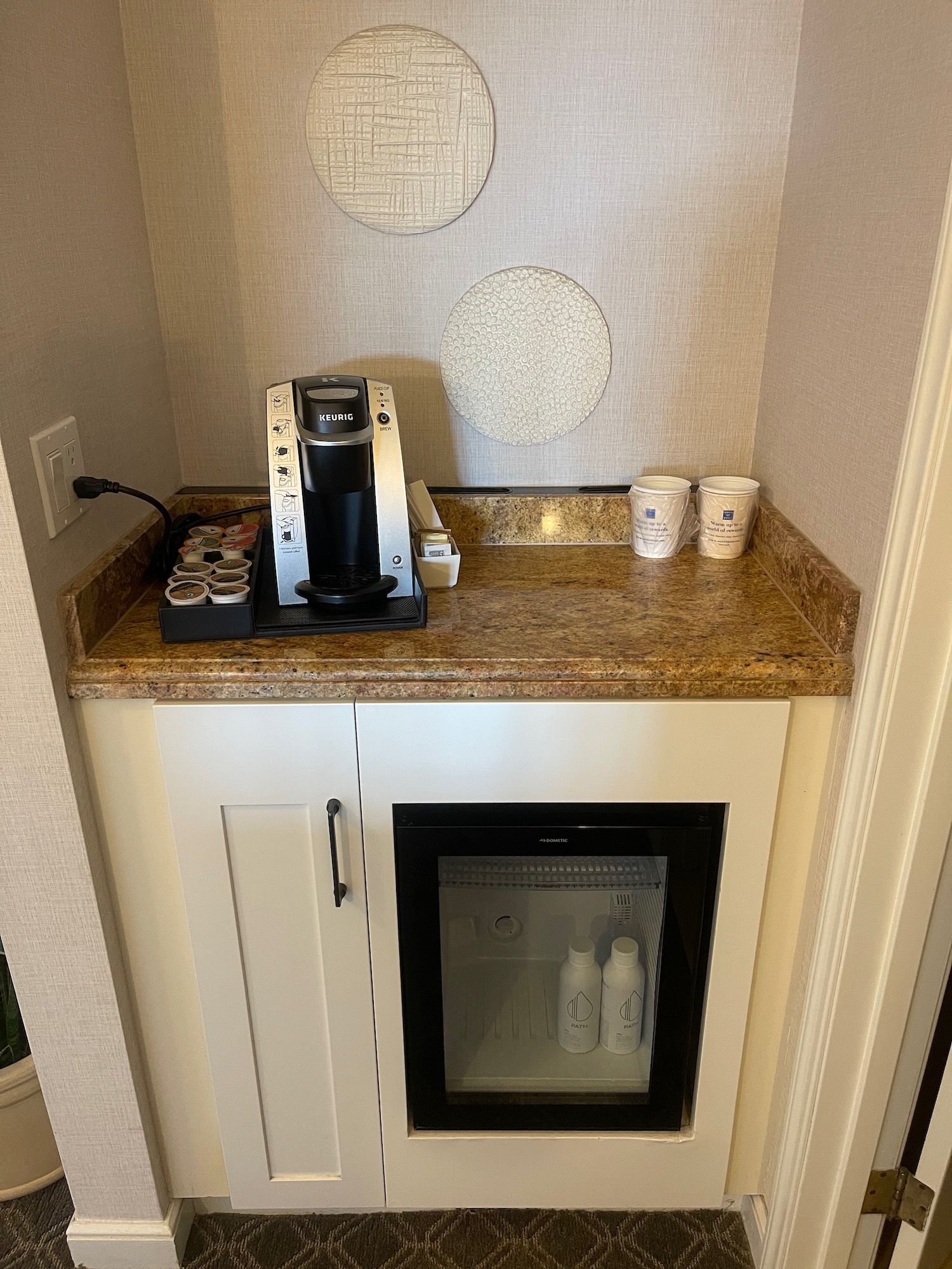 a coffee machine and coffee cups on a counter