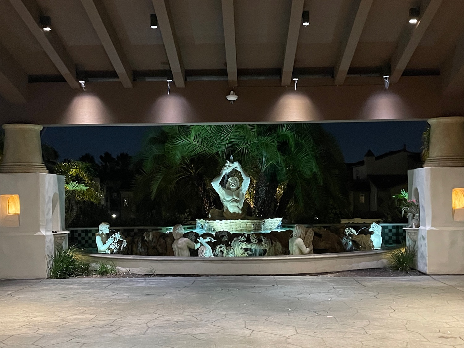 a fountain with statues in front of a building