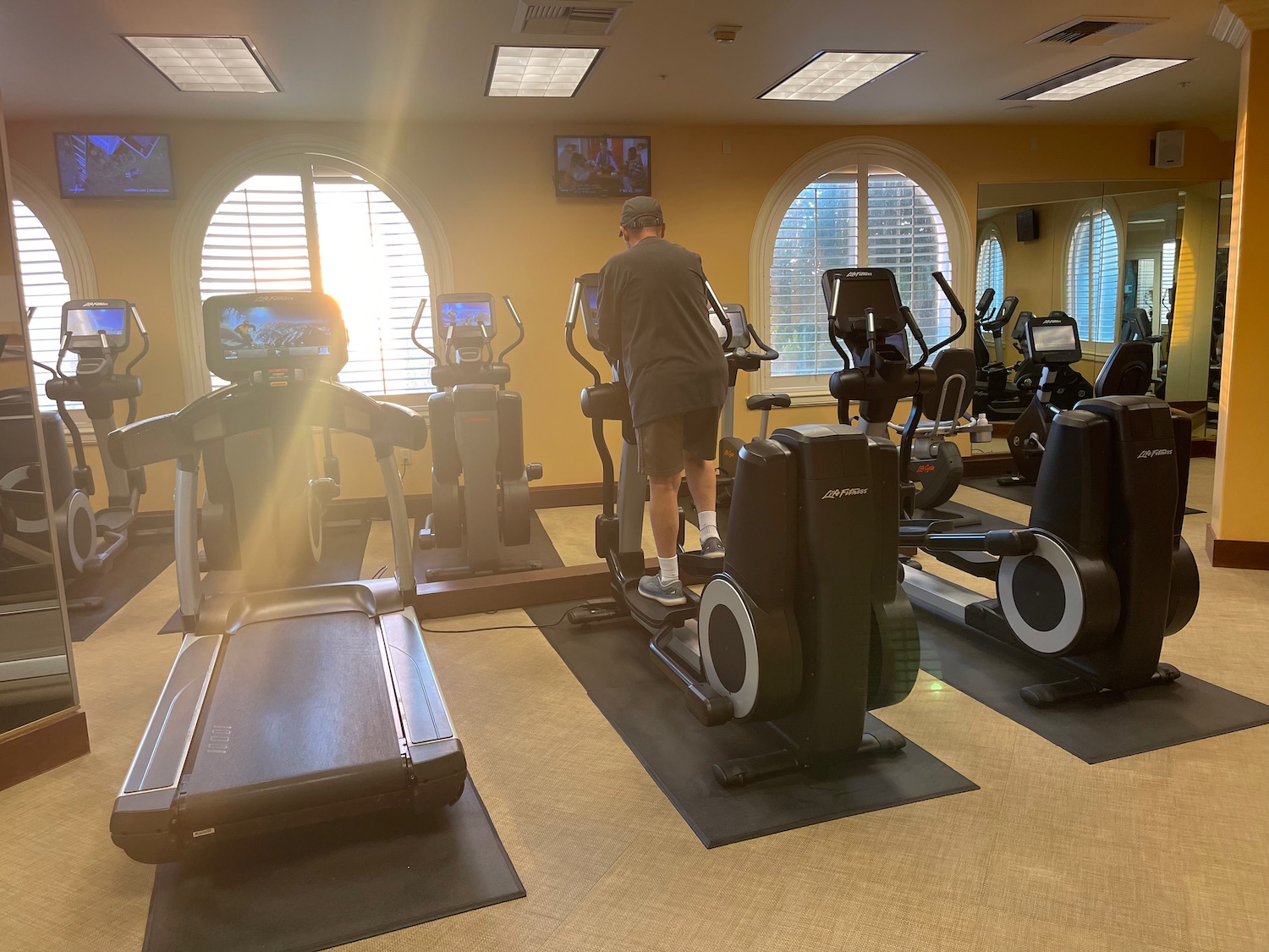 a man standing on exercise machines in a room