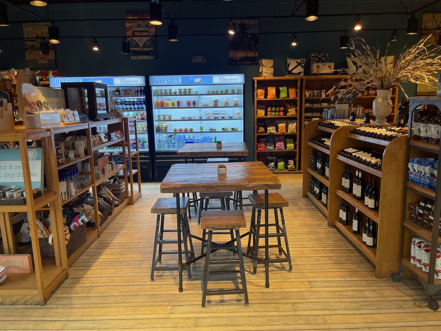 a room with a table and chairs and shelves of beverages