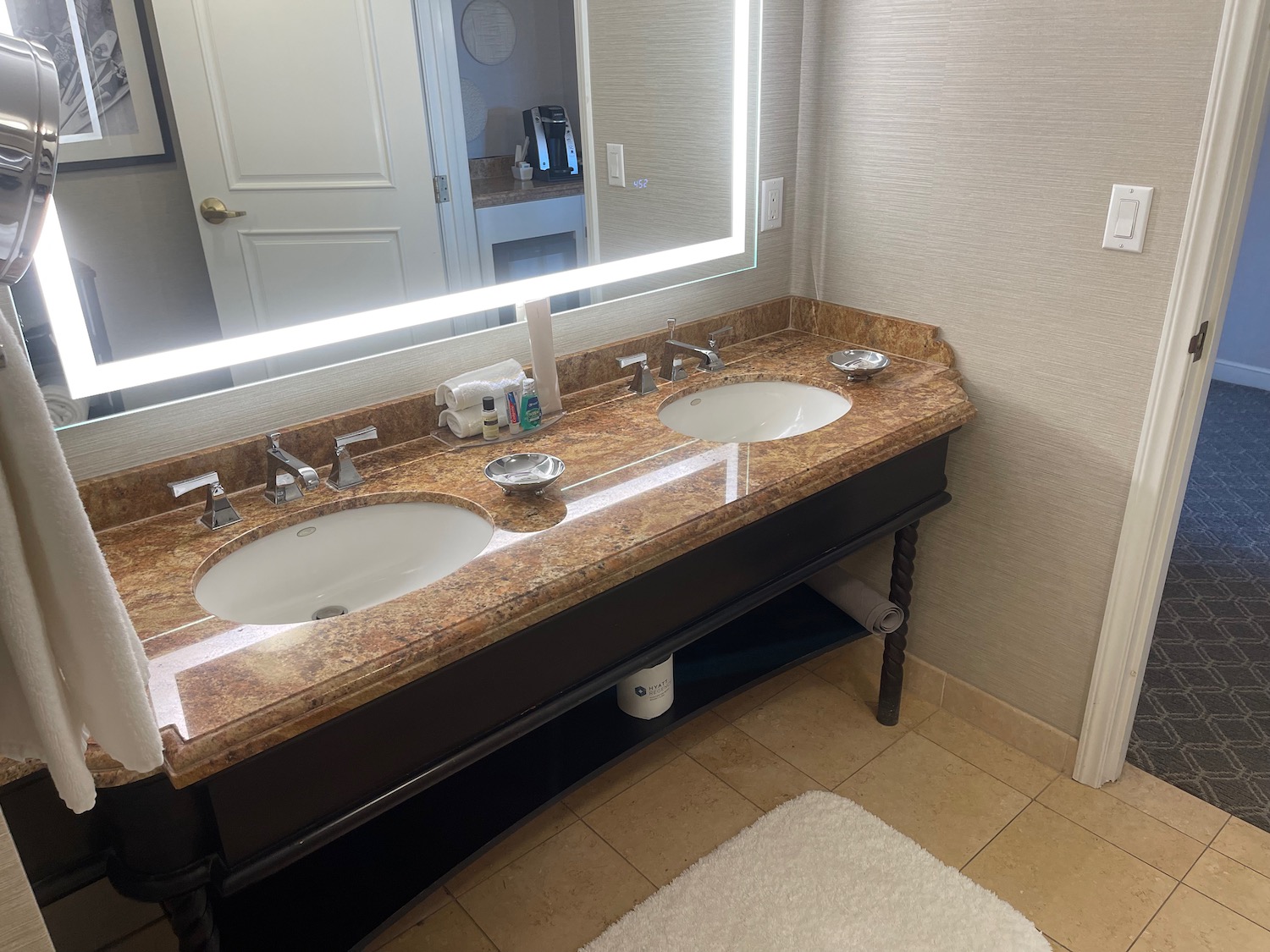 a bathroom with double sinks and a mirror