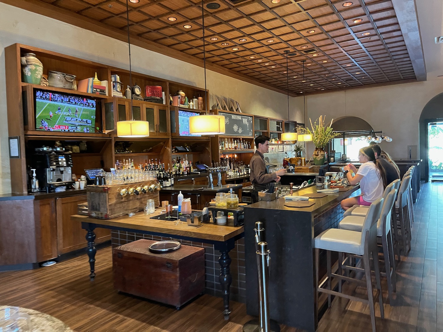 a group of people sitting at a bar