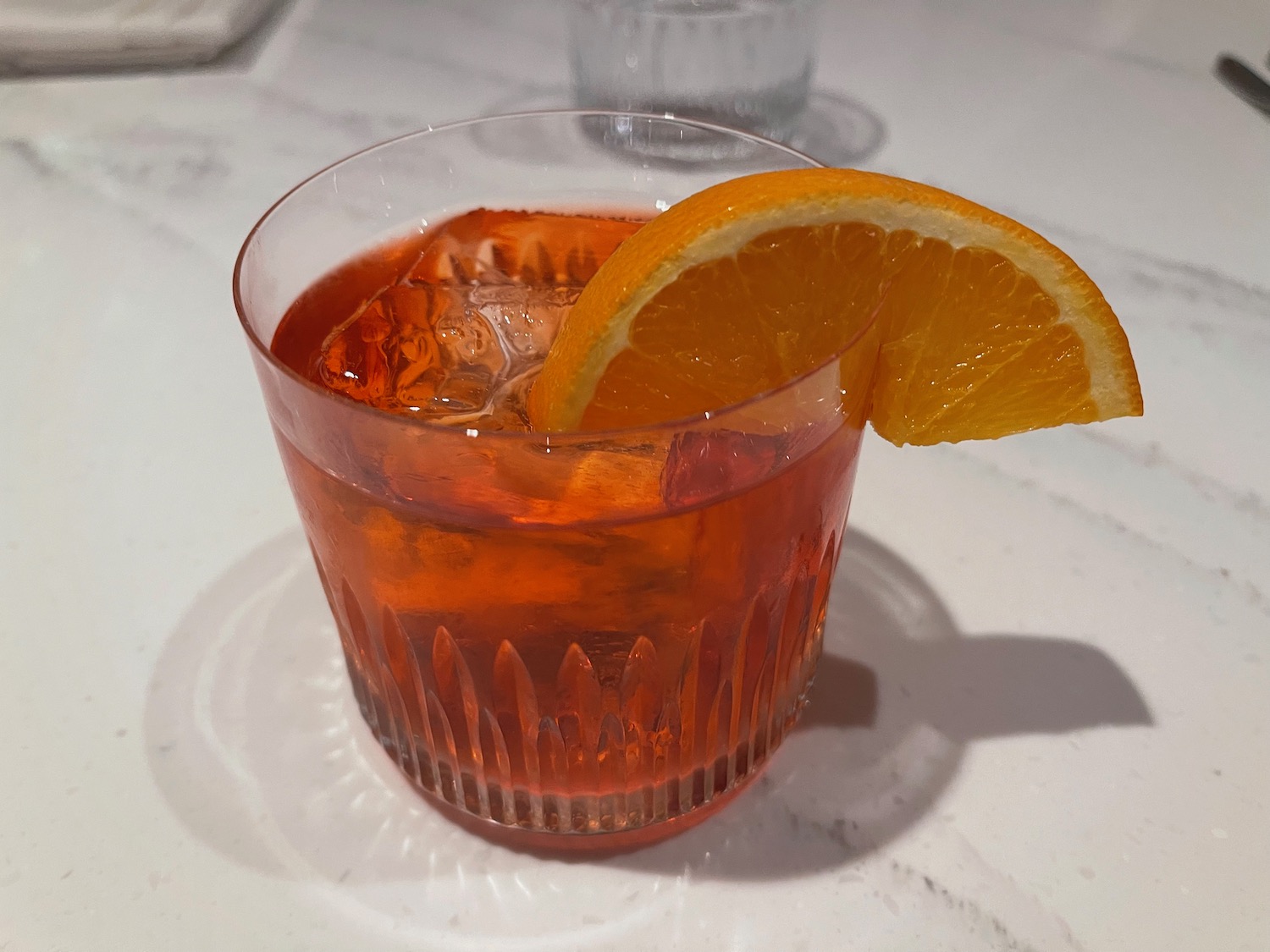 a glass with a drink and an orange slice on it