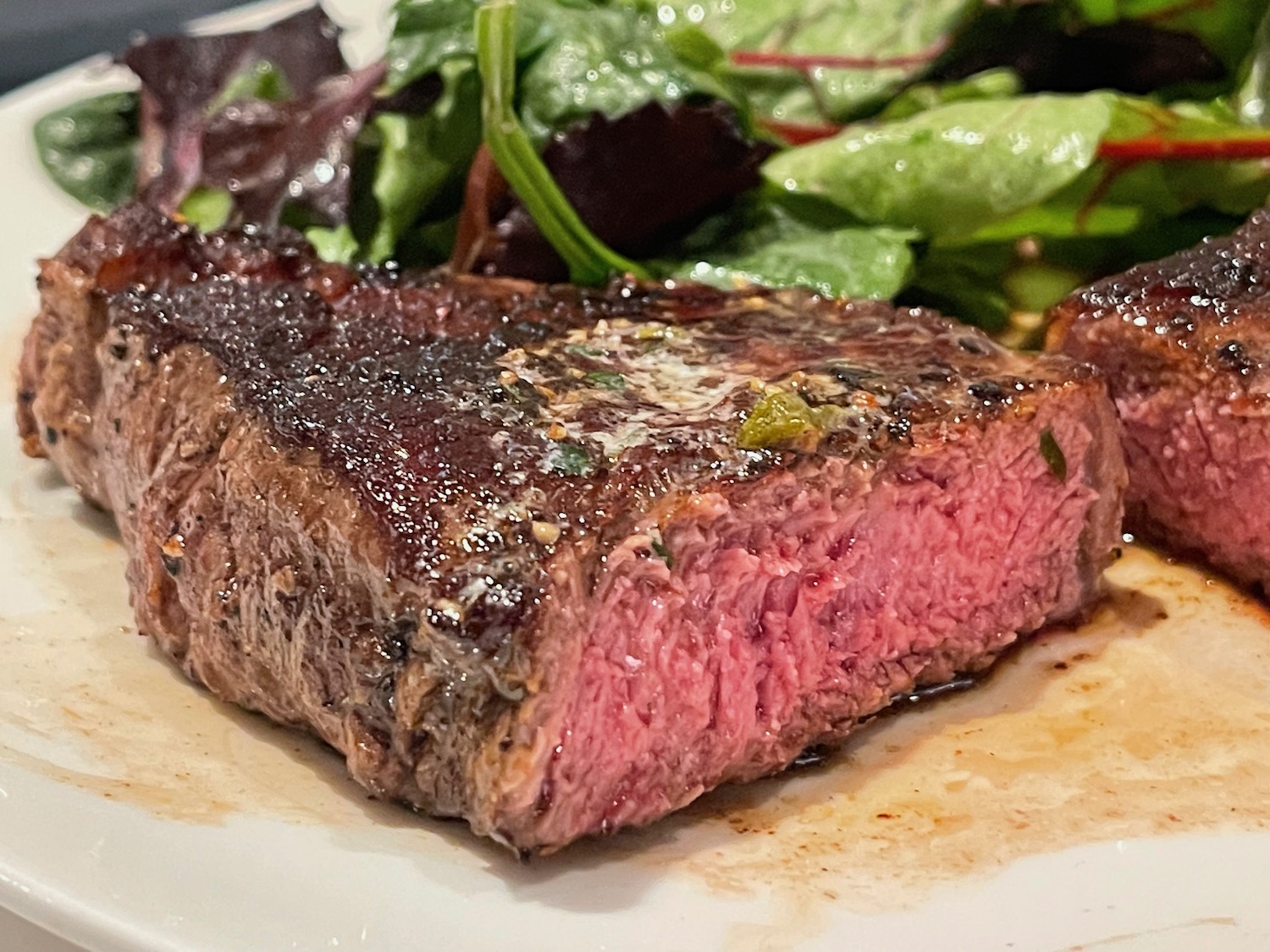 a steak and salad on a plate