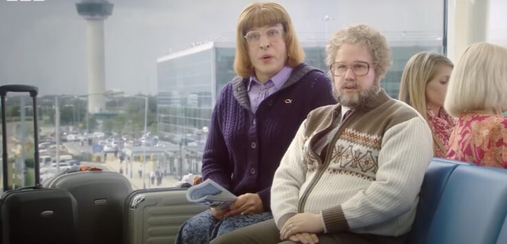 a man and woman sitting on a bench