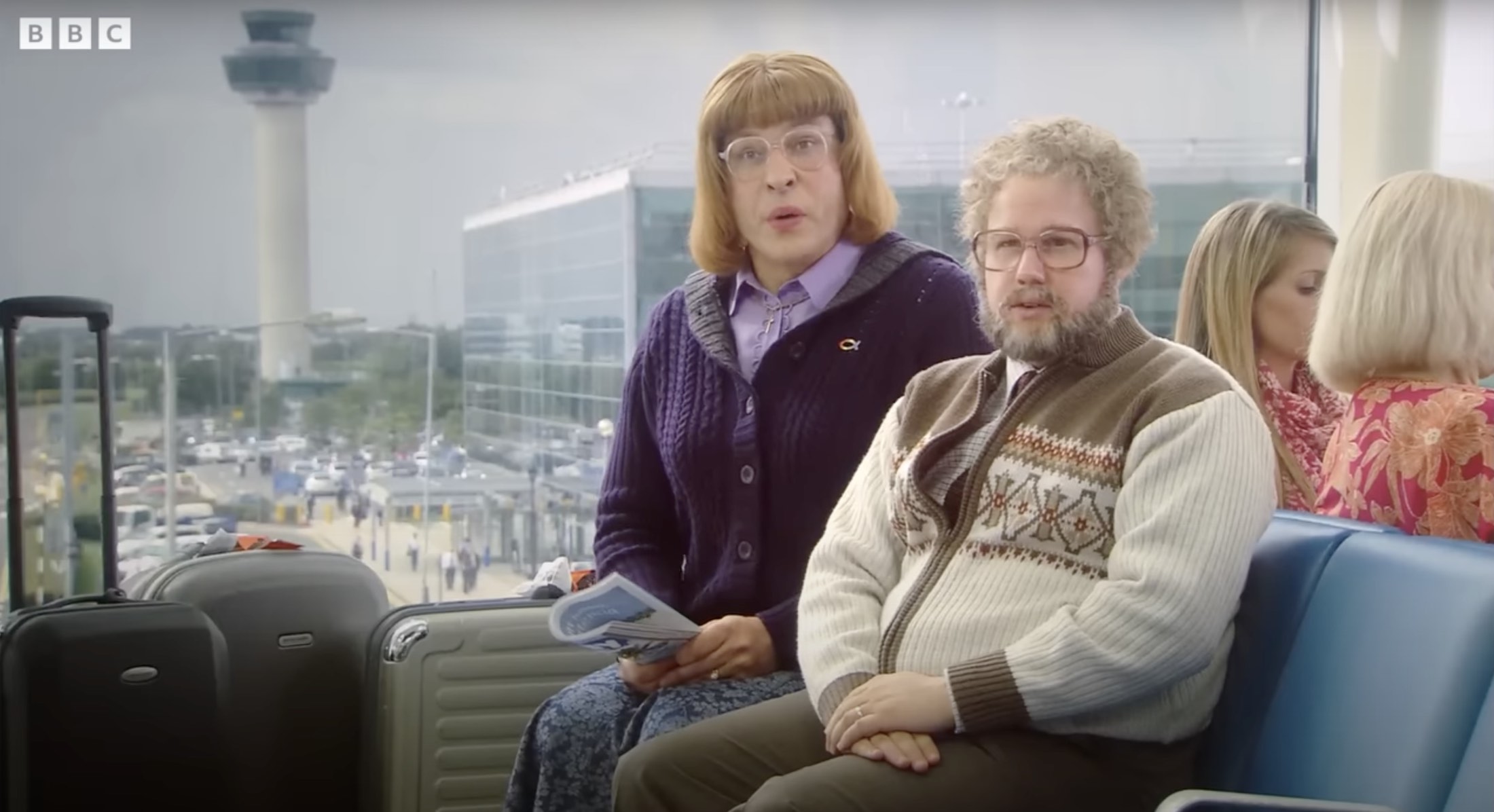 a man and woman sitting on a bench