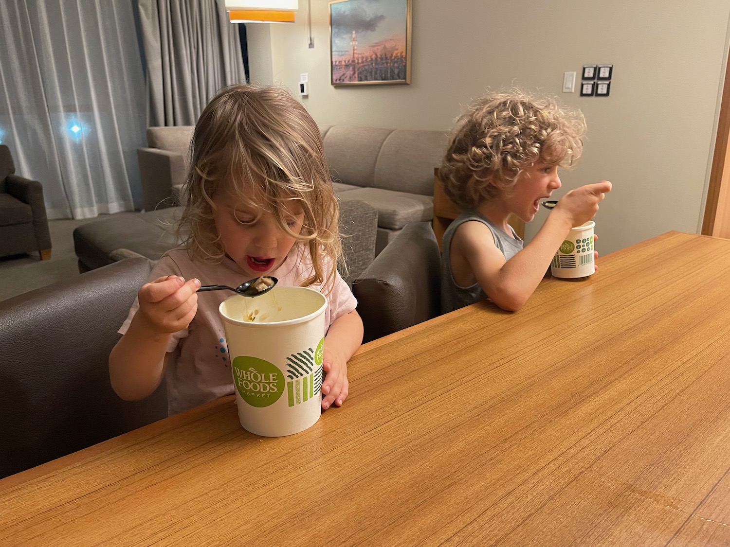 two children eating from a cup