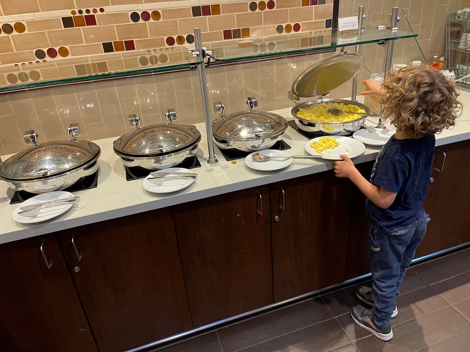 a boy standing at a buffet