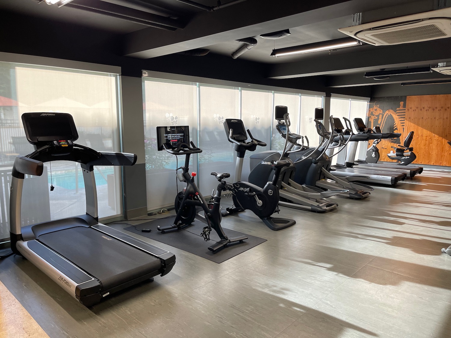 a room with exercise machines and treadmills