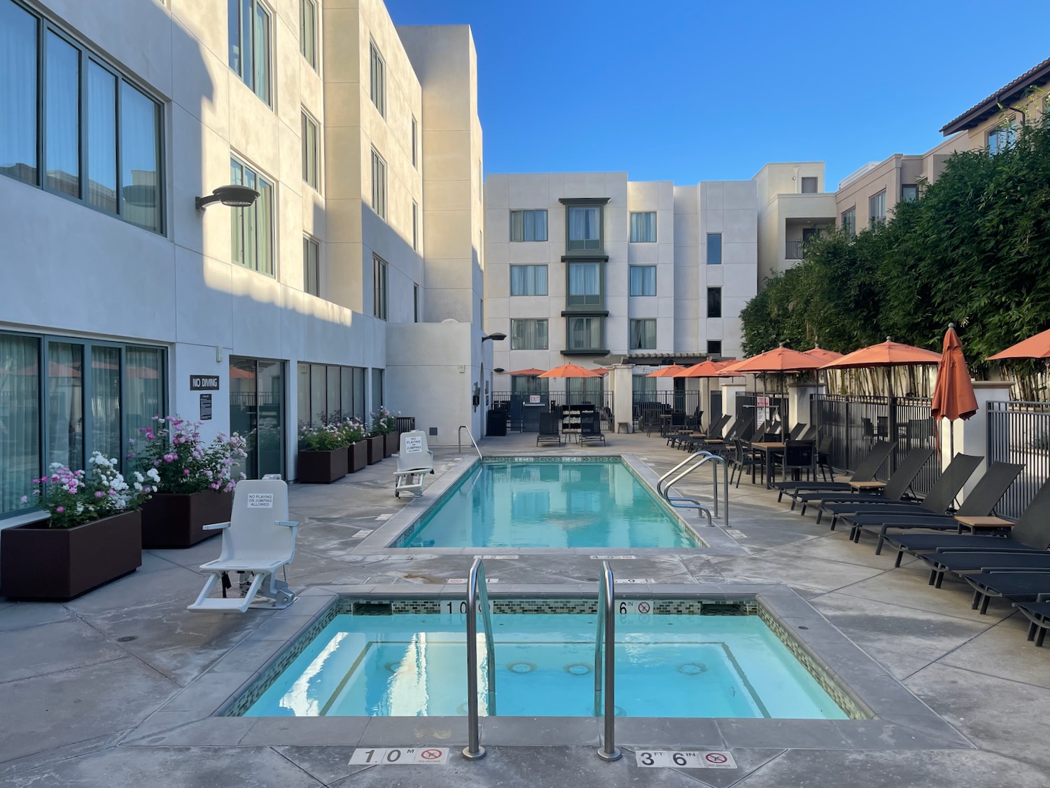 a pool and chairs in a hotel