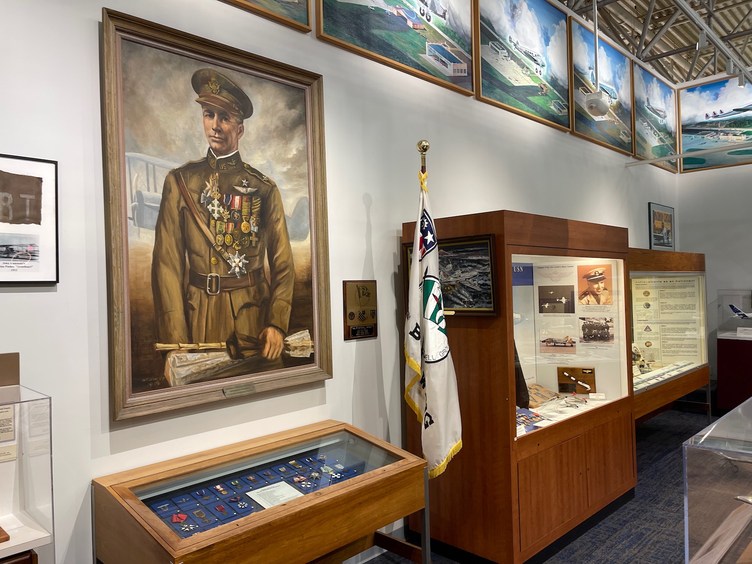 a display case with a flag and a picture of a man in uniform