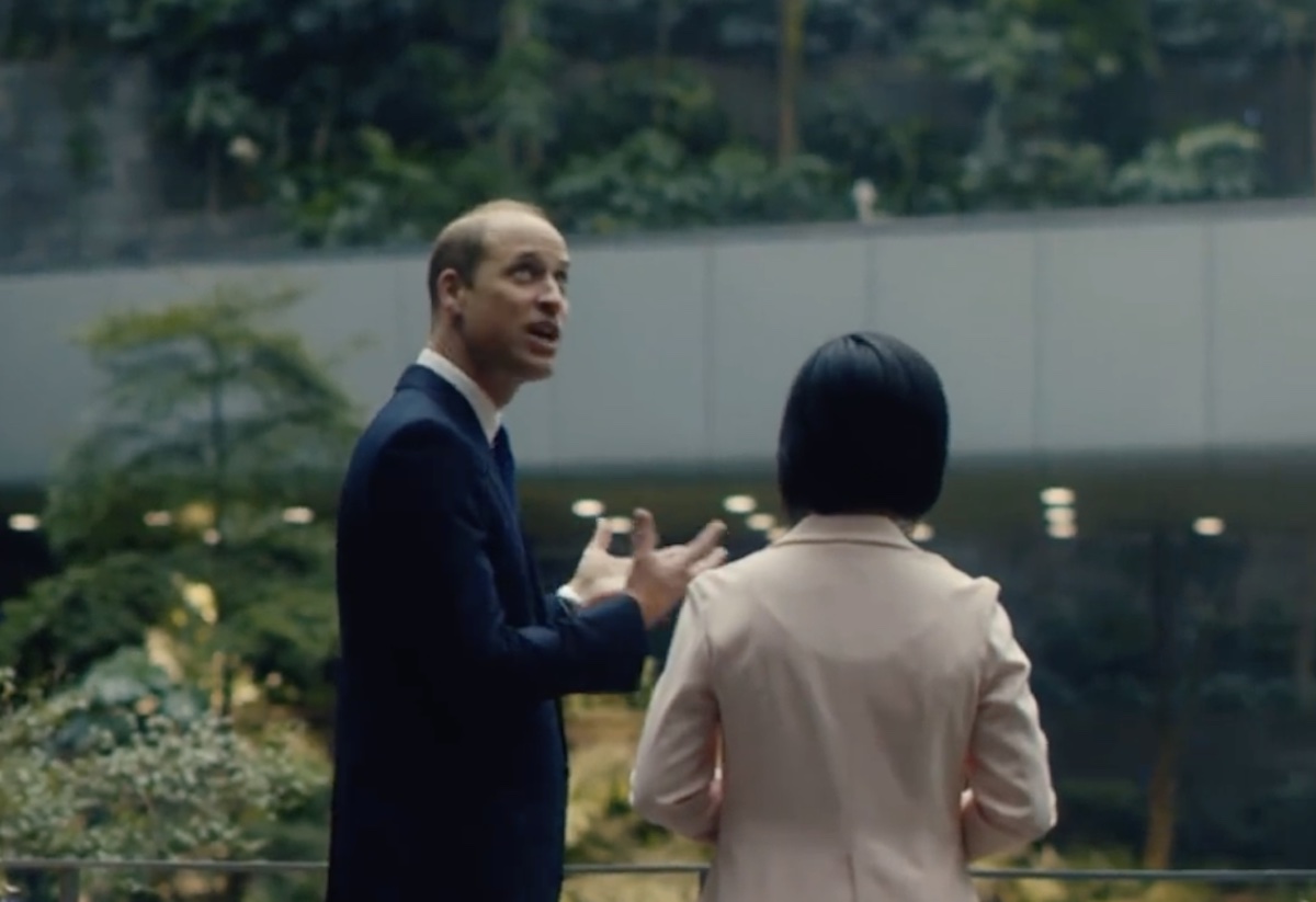 a man in a suit talking to a woman