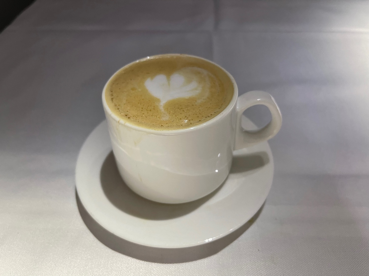 a cup of coffee with a heart shaped foam