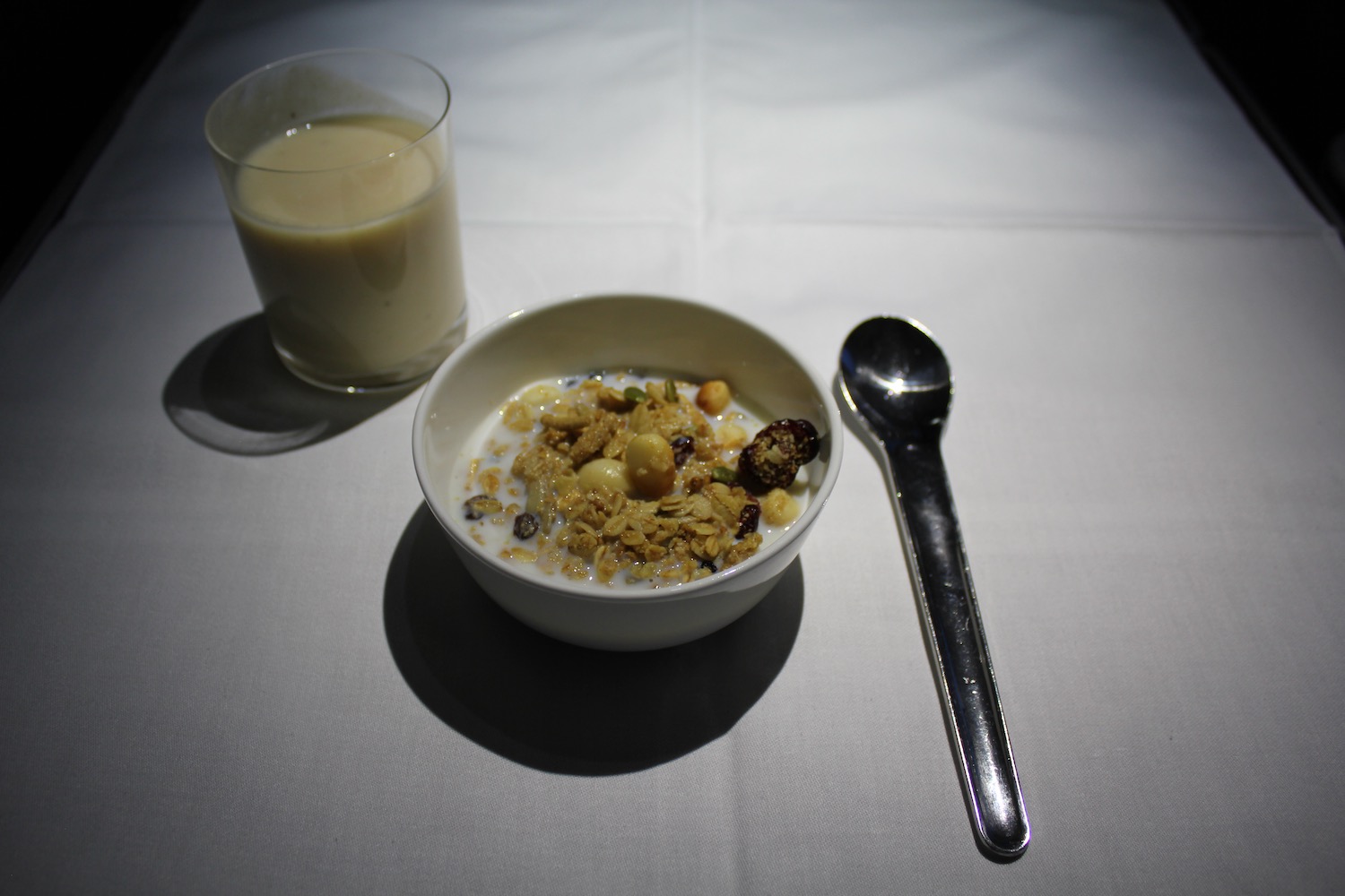 a bowl of cereal and milk with a spoon