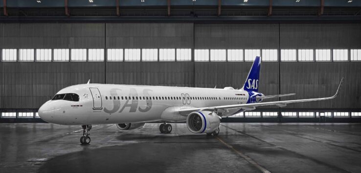 a large white airplane in a hangar