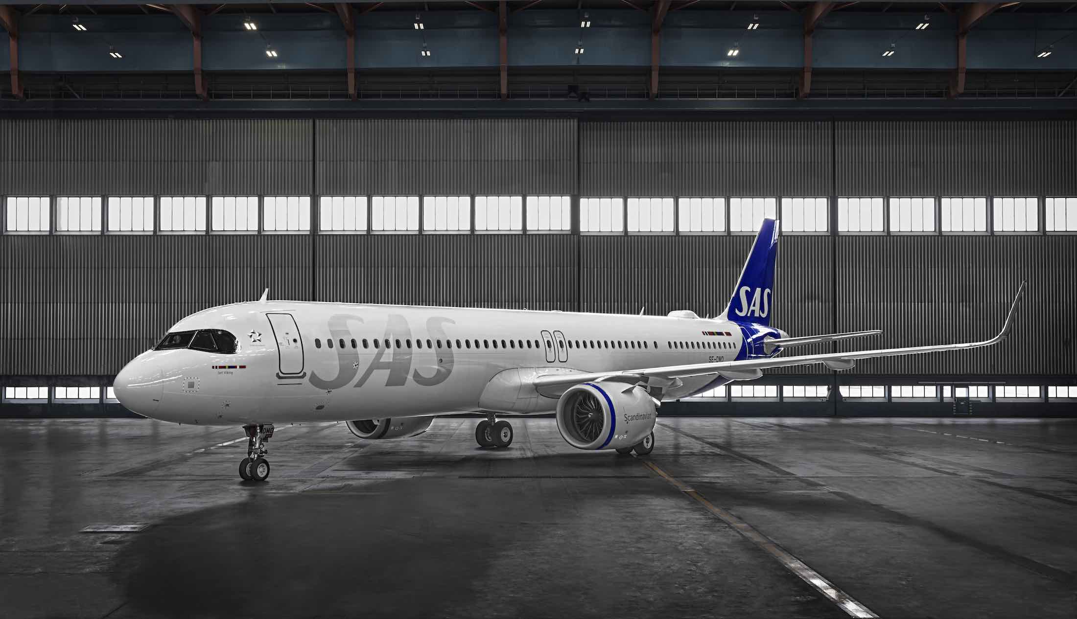 a large white airplane in a hangar