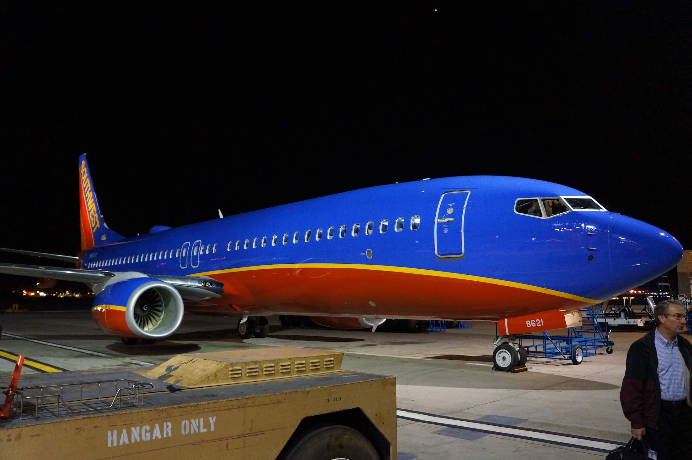 a blue and orange airplane at night