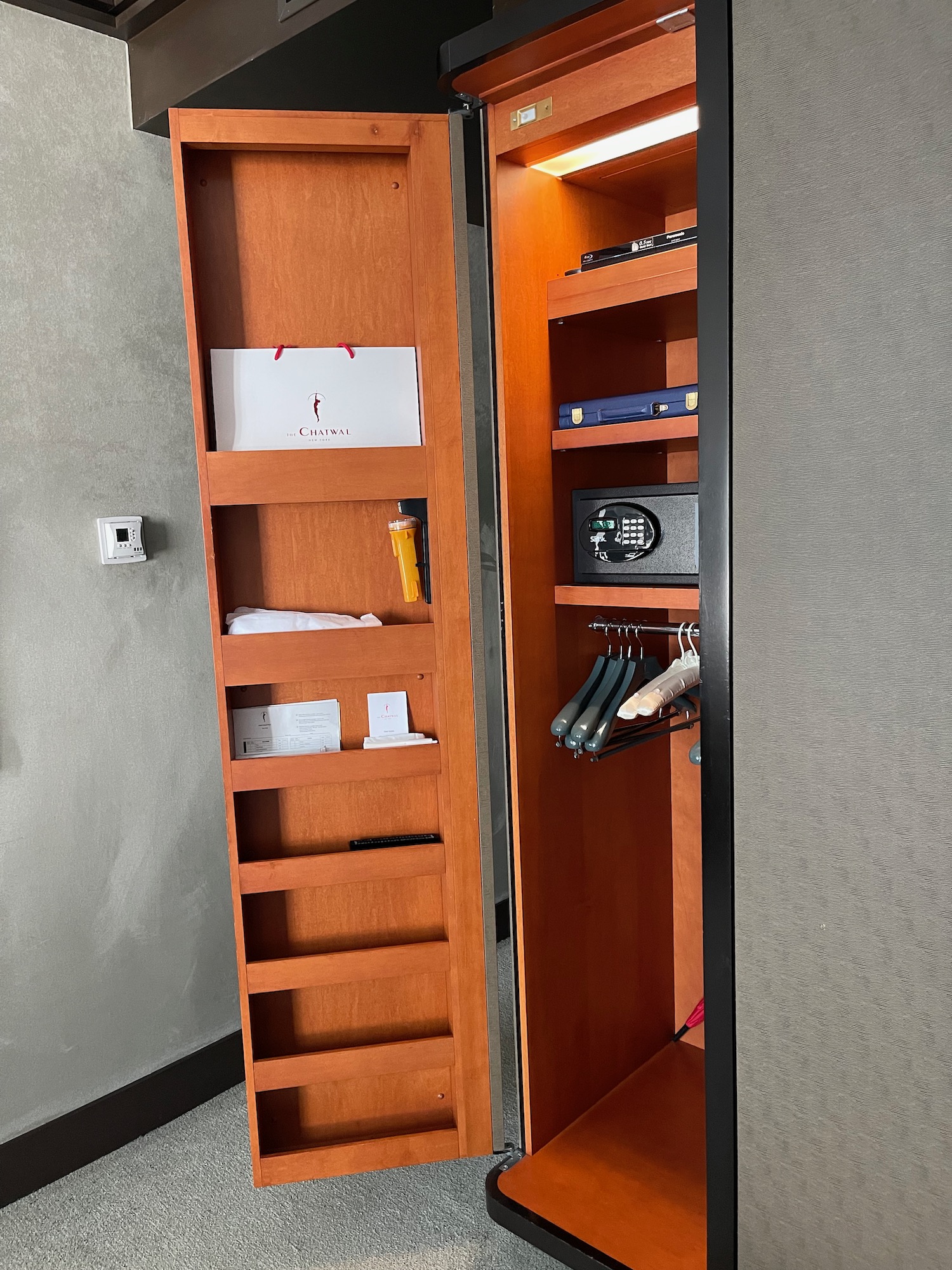 a wooden shelf with a door open