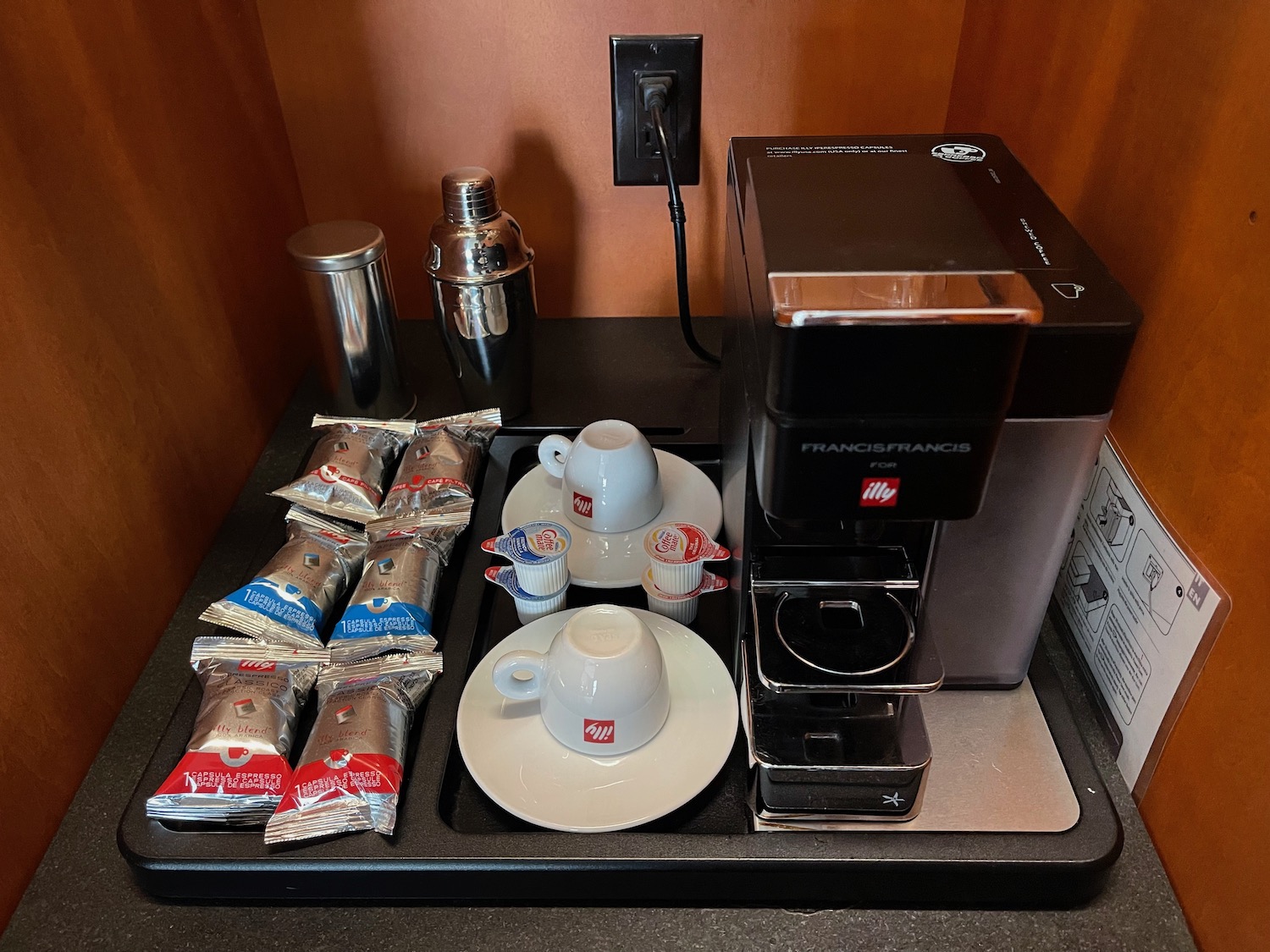 a coffee machine and coffee cups and sugar packets