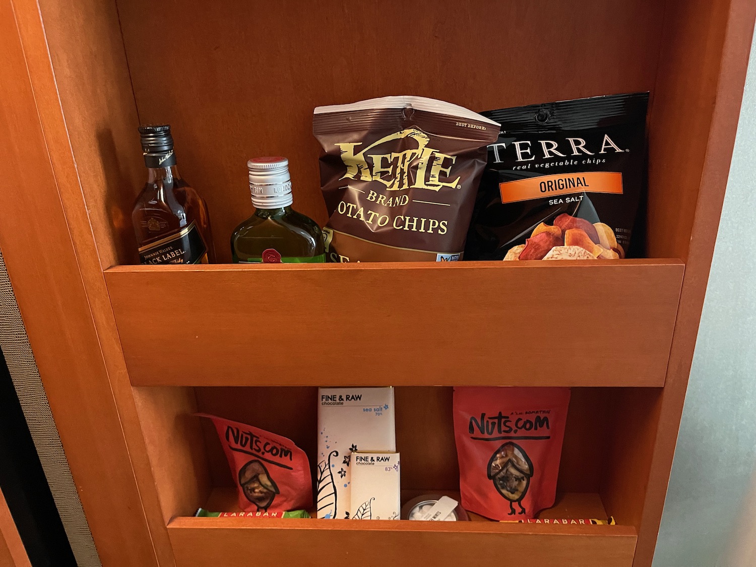 a shelf with snacks and bottles