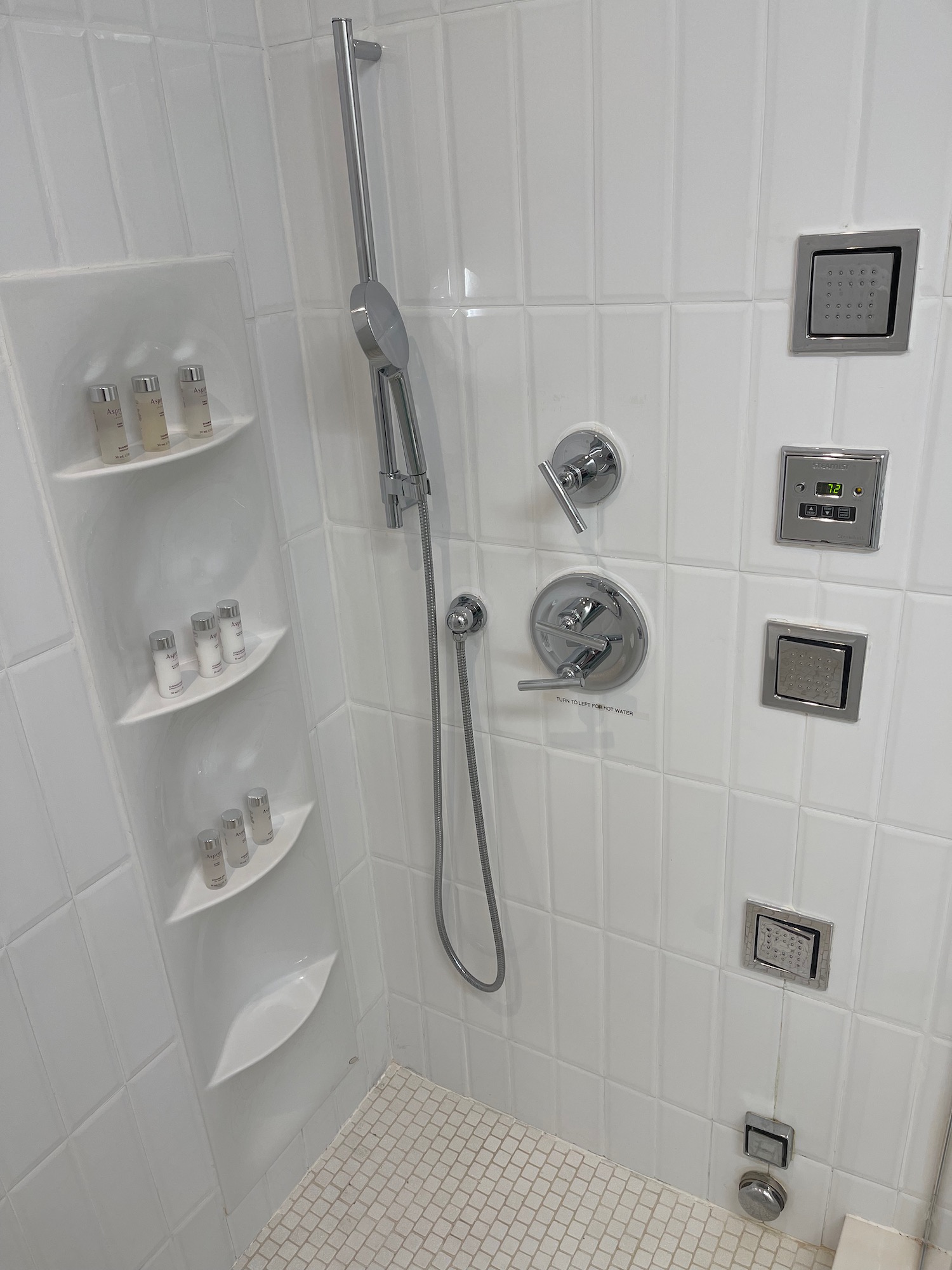 a shower with a shower head and a shower head