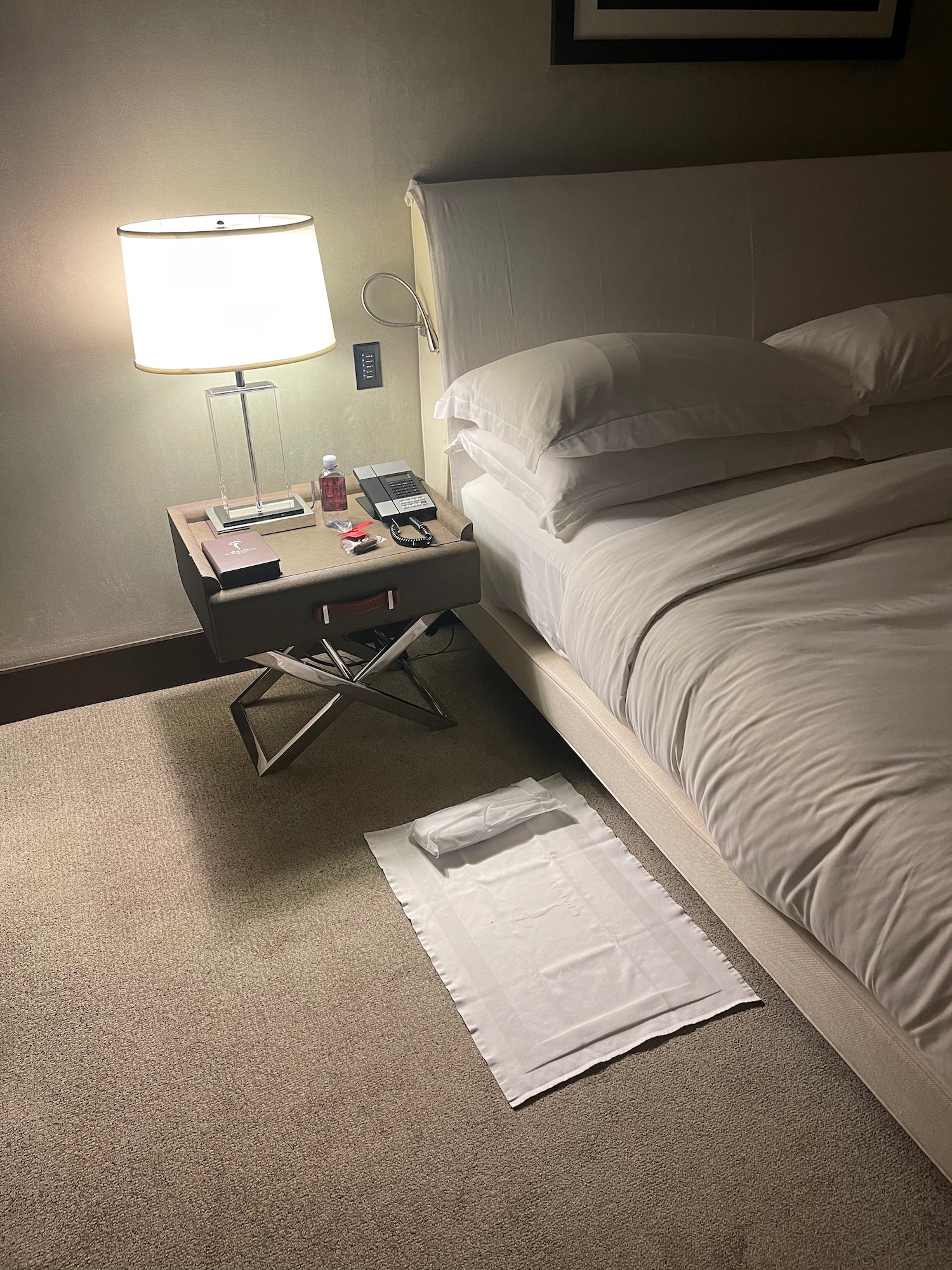 a bed with a lamp on a table