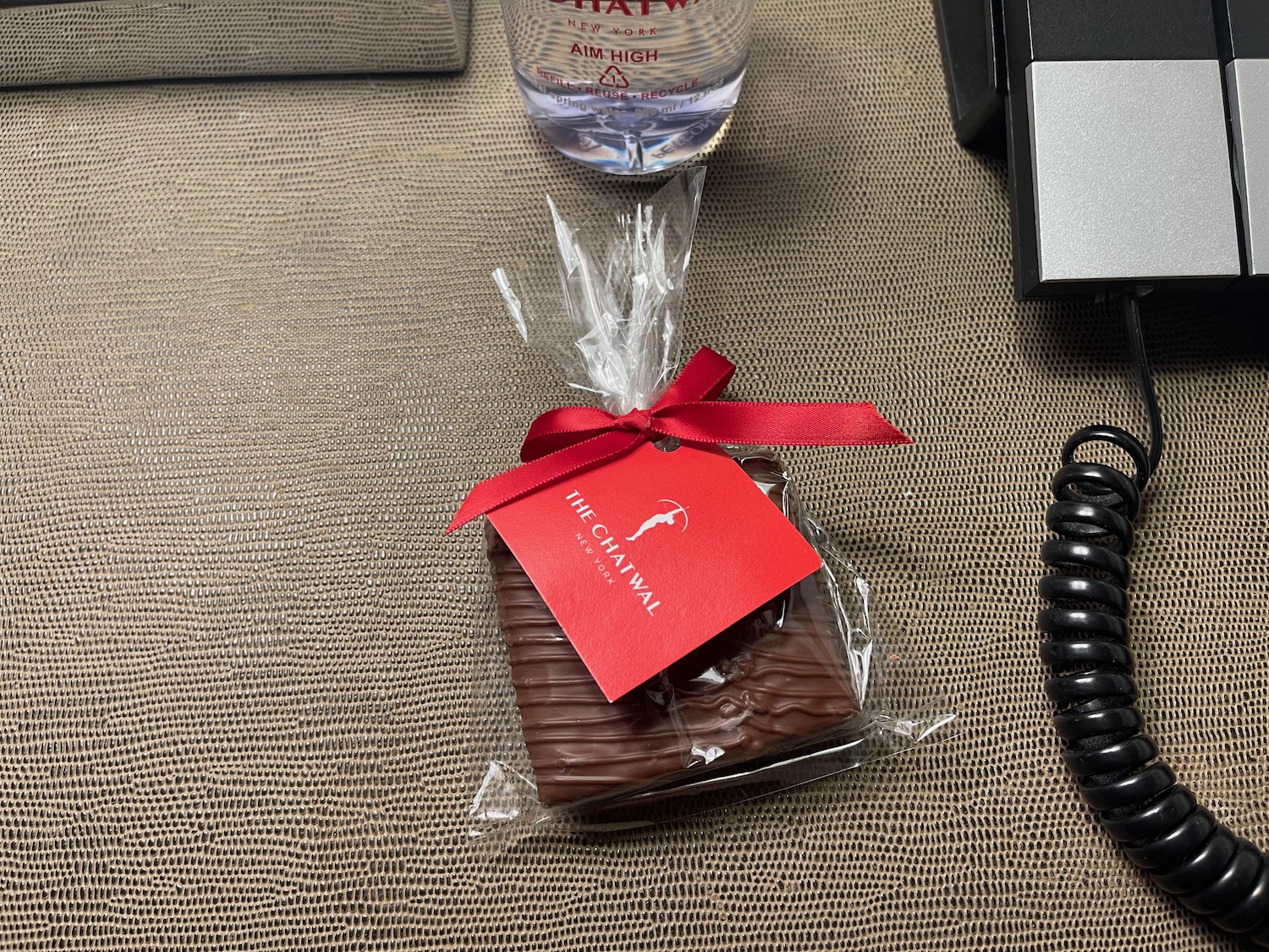a chocolate bar wrapped in a wrapper with a red bow