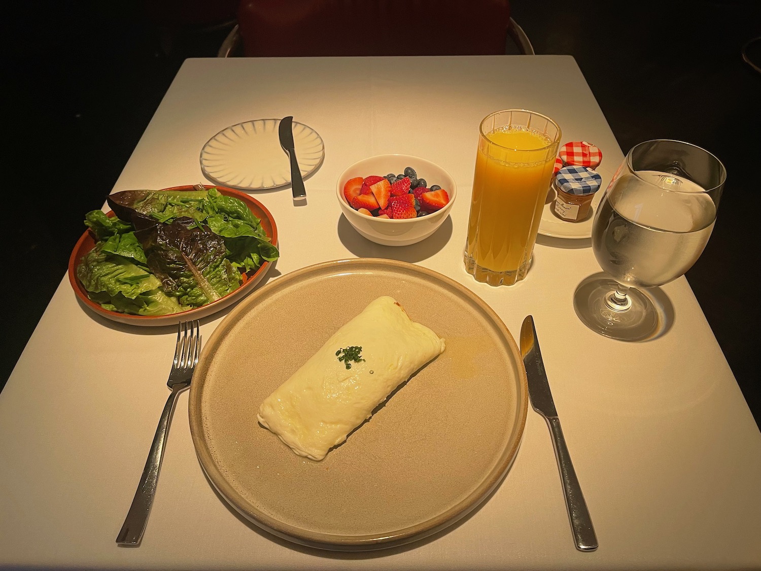a plate of food and a glass of water on a table