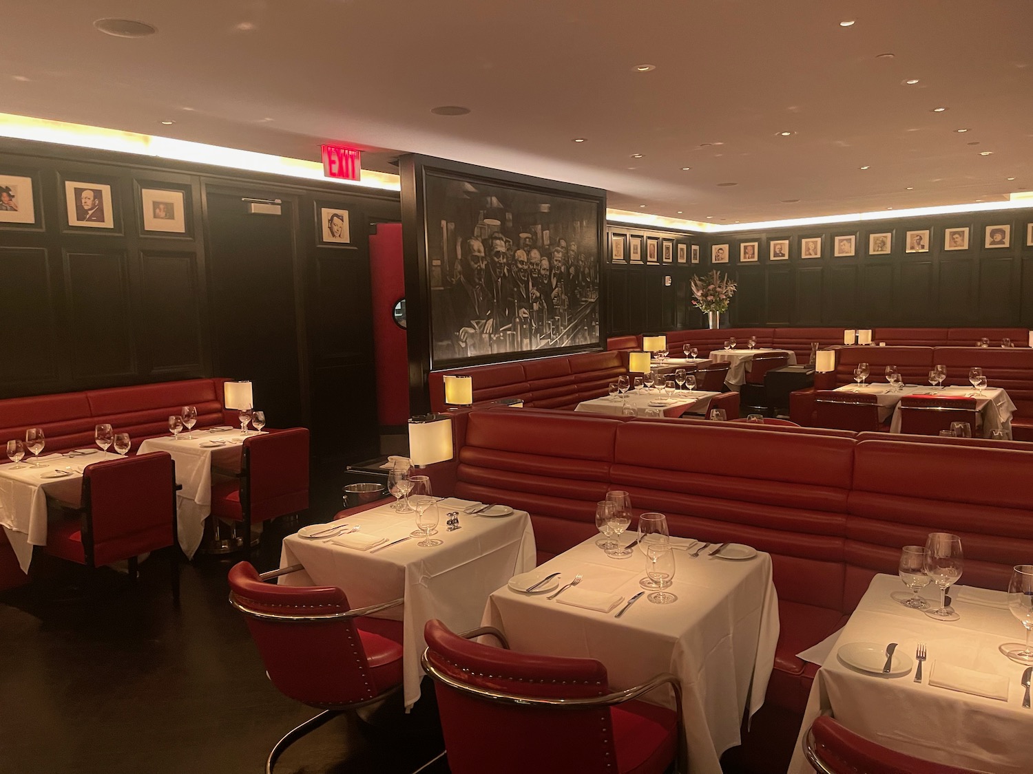 a restaurant with red booth seats and tables