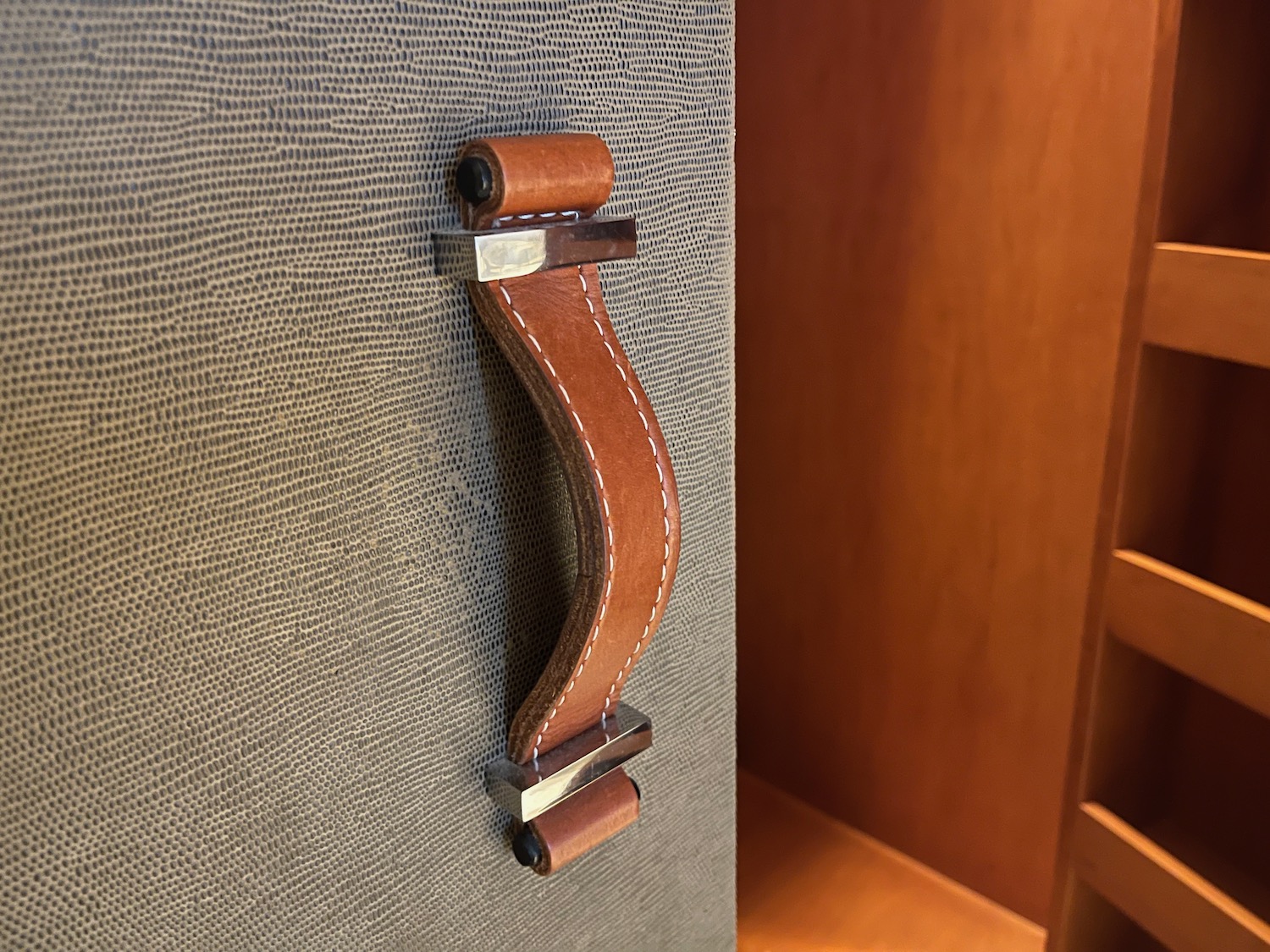 a brown leather handle on a grey surface