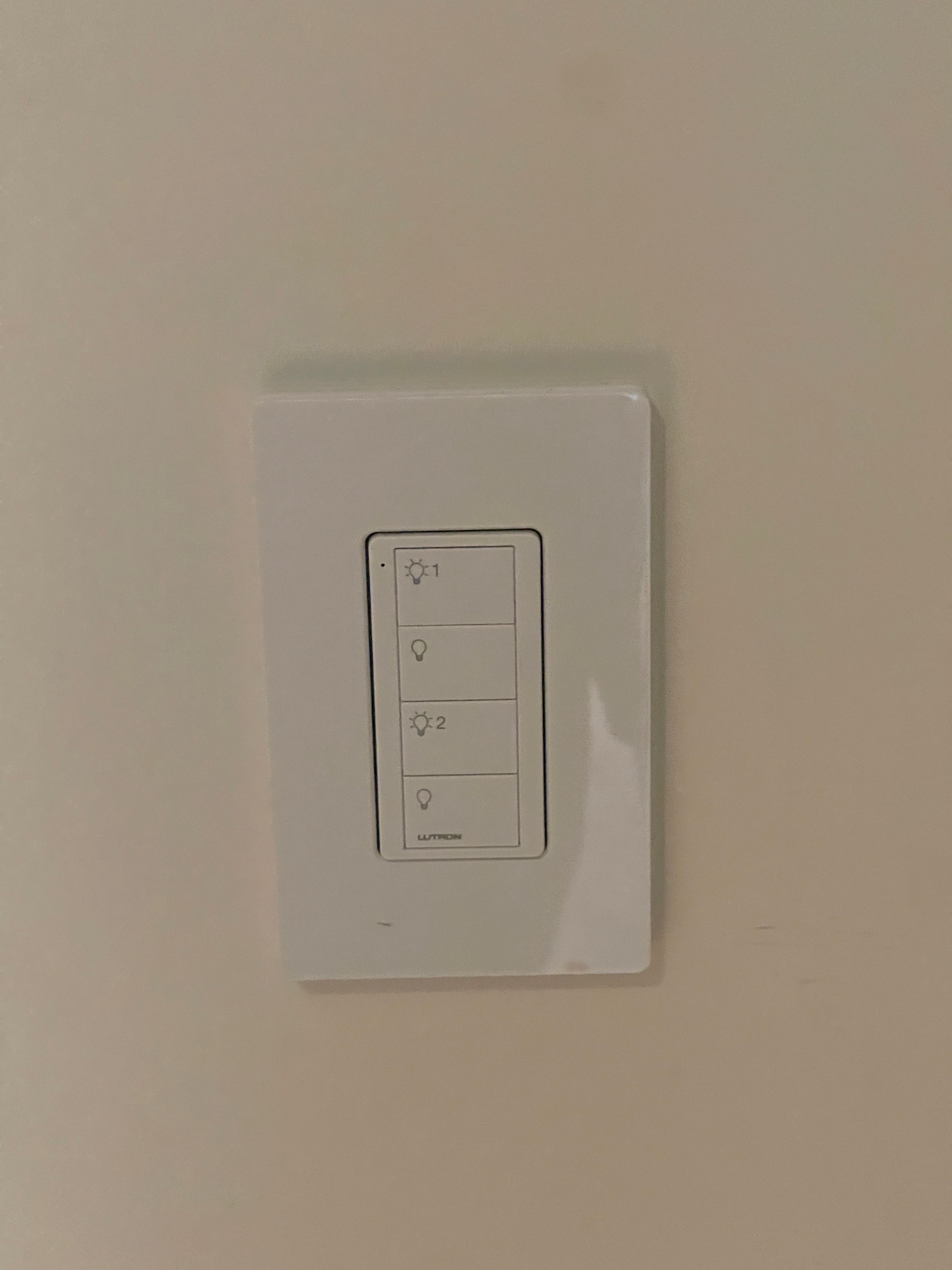a white rectangular wall switch with buttons