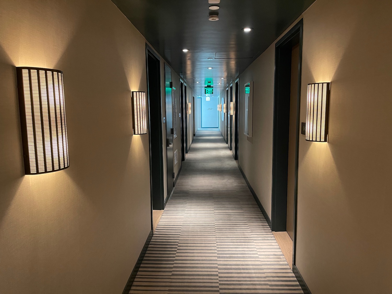 a hallway with lights and doors