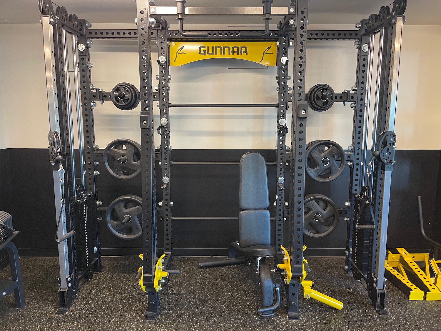 a gym with weights and a chair