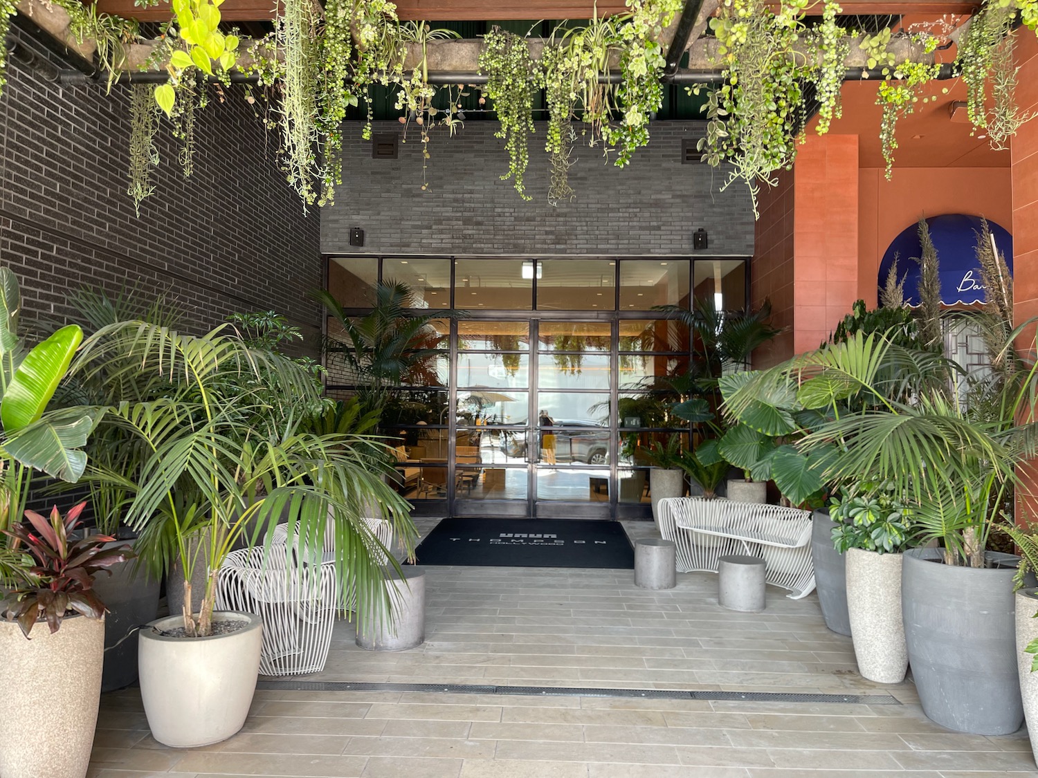 a front entrance of a building with plants