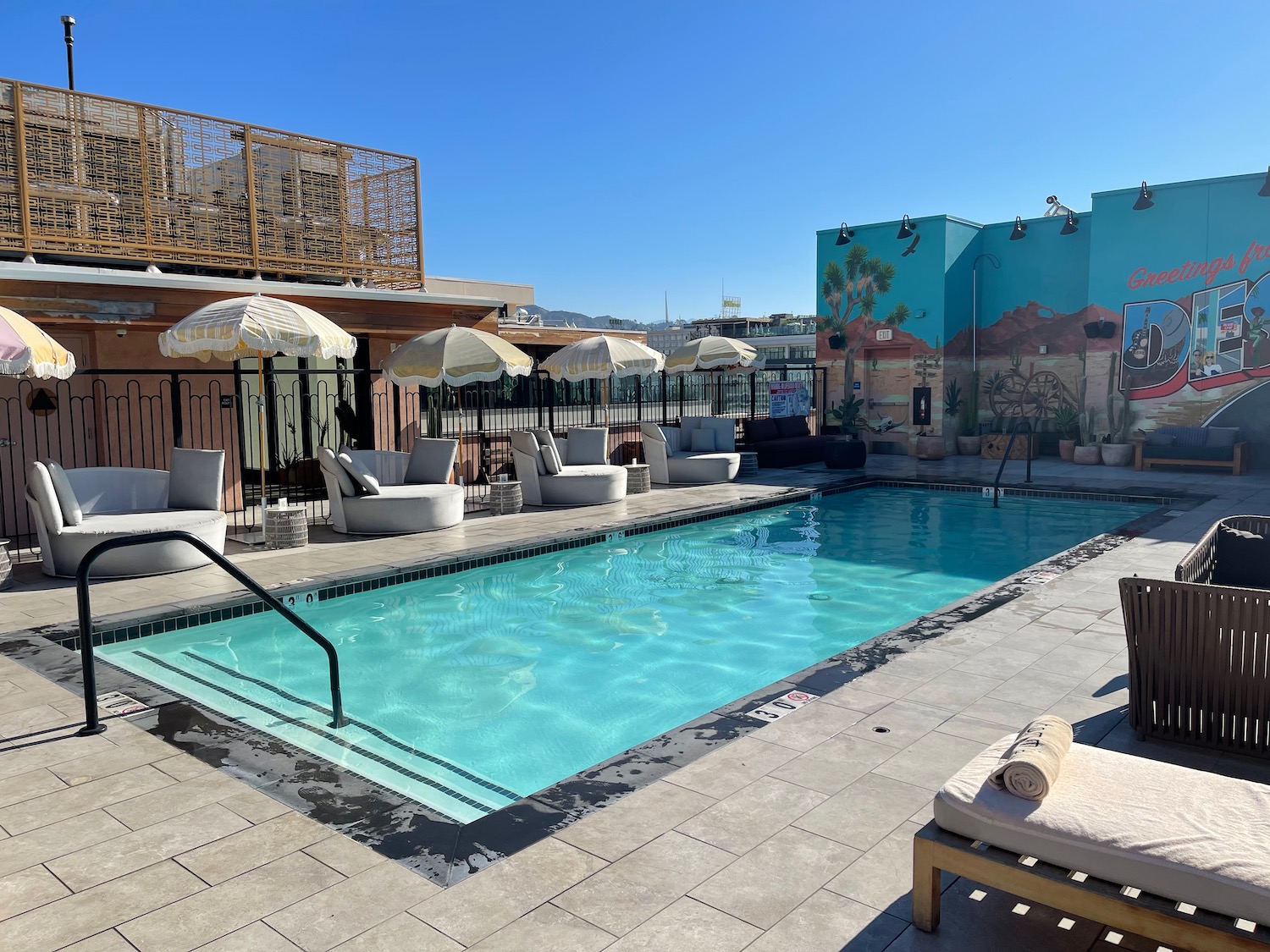 a pool with chairs and umbrellas