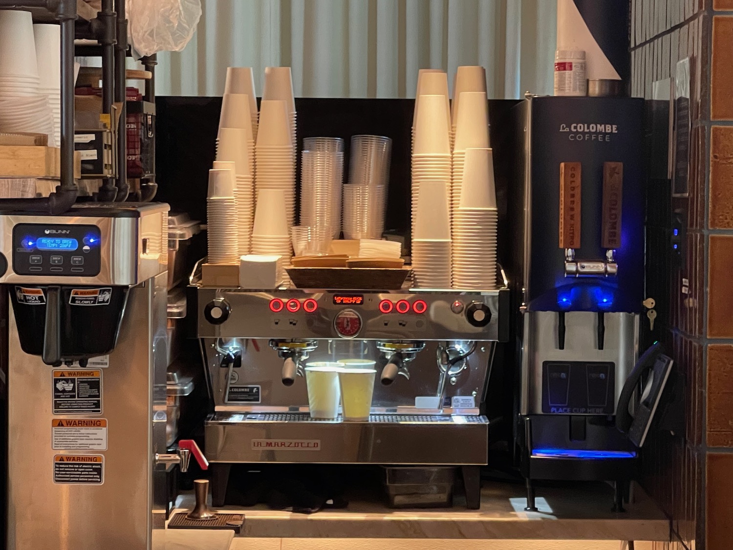 a coffee machine with a stack of cups