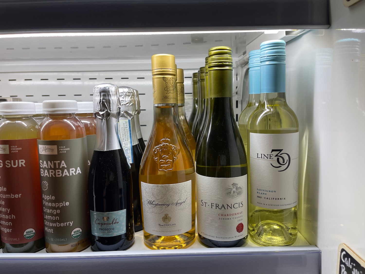 a shelf with bottles of alcohol