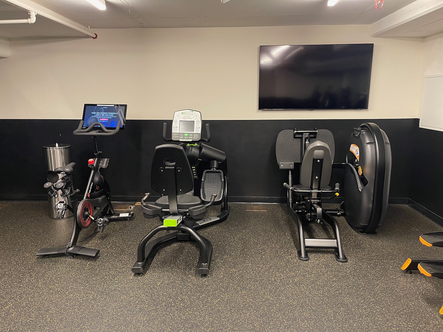 a group of exercise machines in a room