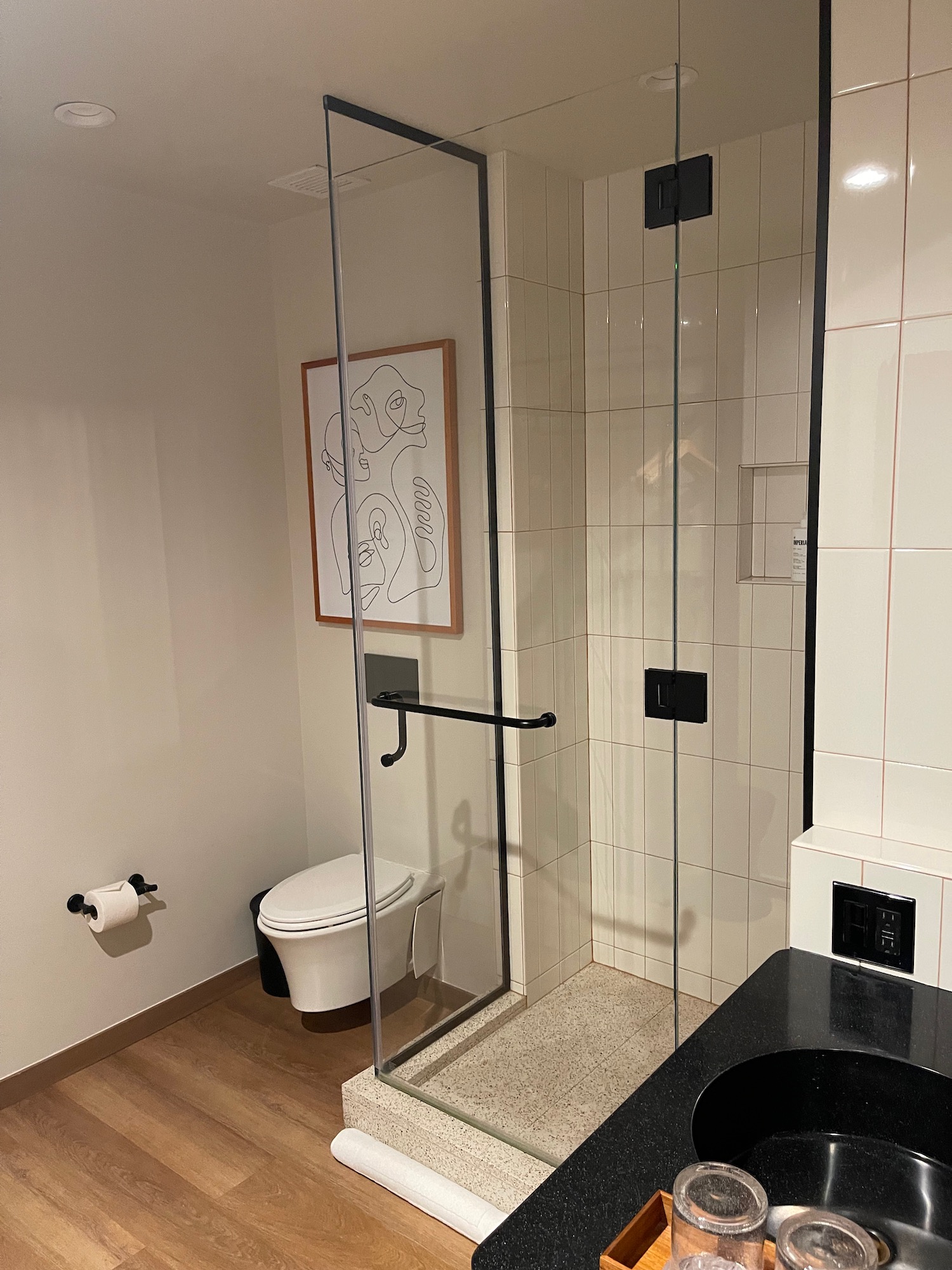 a bathroom with a glass shower door