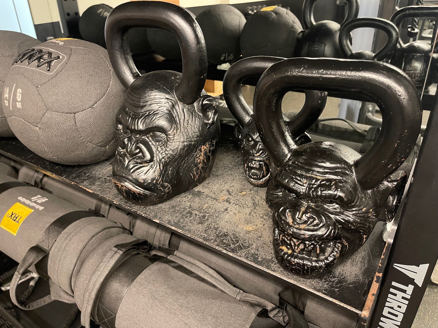 a group of kettlebells on a shelf