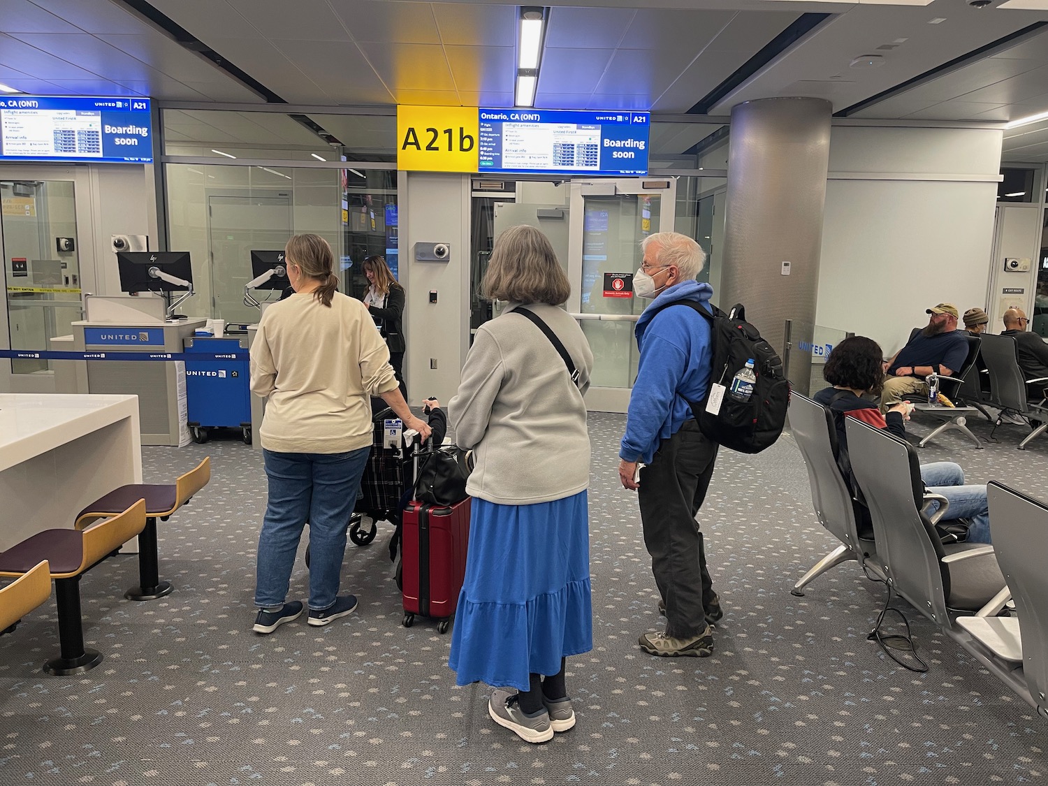 a group of people standing in a waiting room