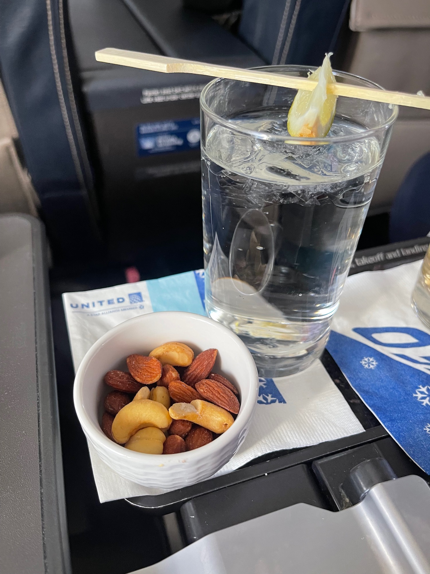 a bowl of nuts and a glass of water